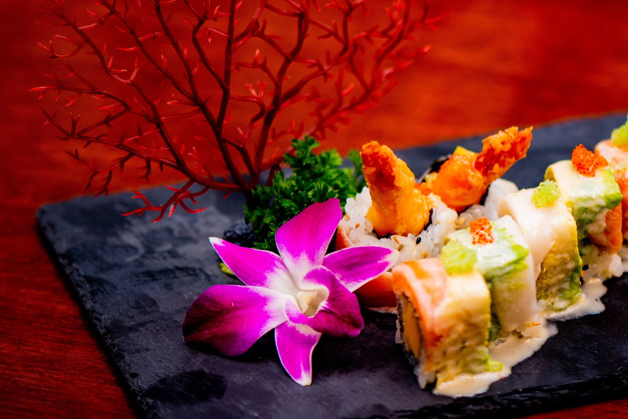 Artfully arranged sushi platter with shrimp and decorative flower