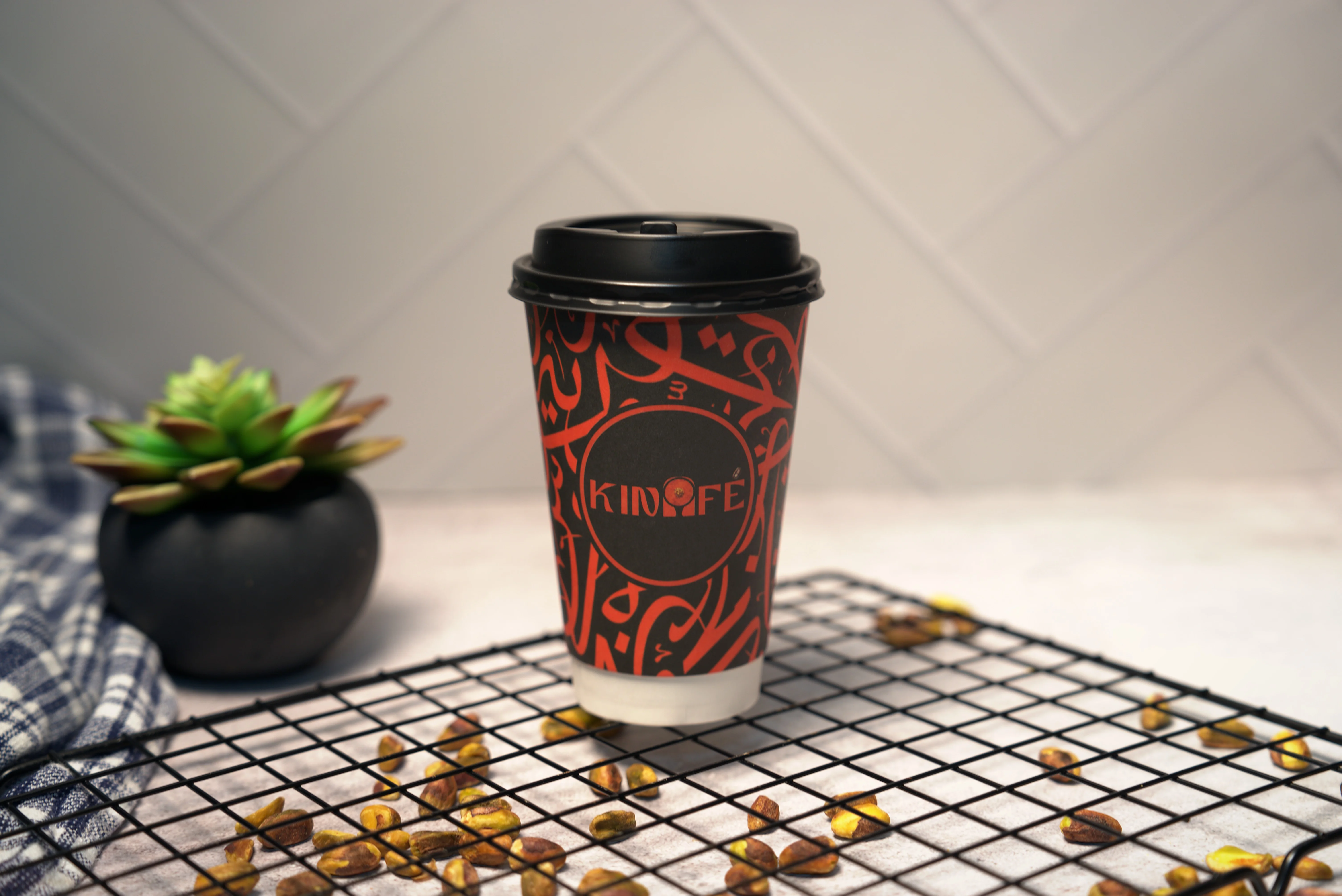 A close-up of a clear cup filled with iced coffee, featuring a rich caramel color and visible ice cubes.