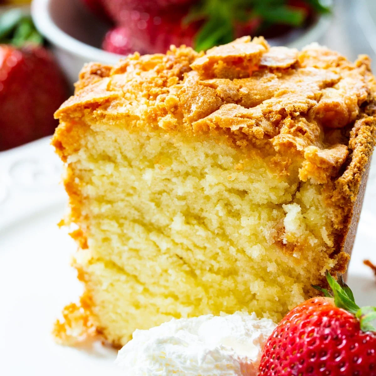 Delicious pound cake slice with fresh strawberries and whipped cream