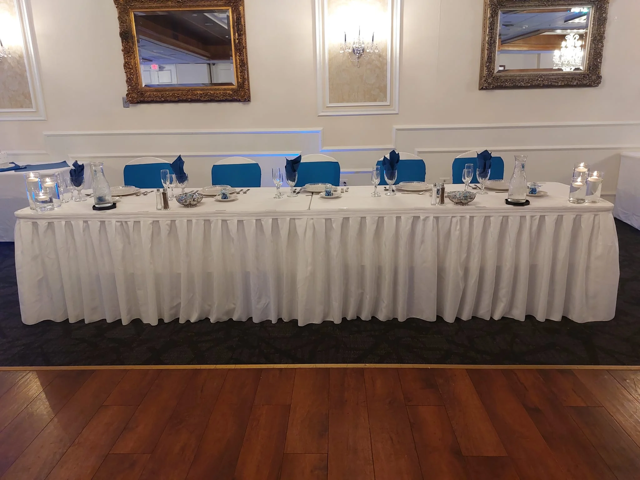 Elegant dining setup with white tablecloth and blue accents