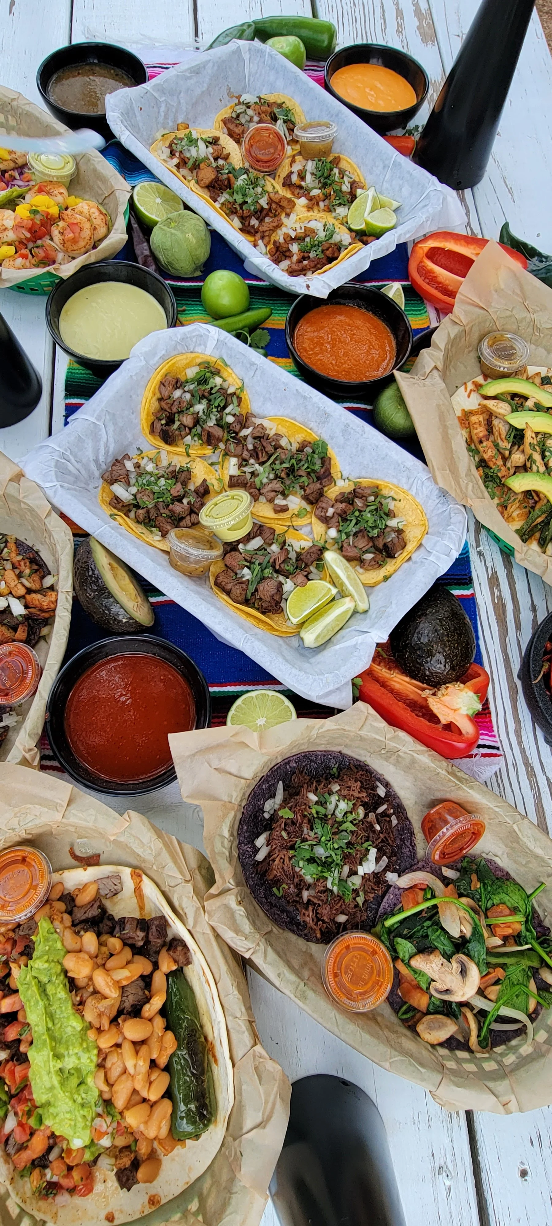 Assorted Mexican tacos with vibrant toppings and salsas