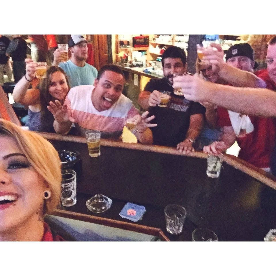 Enthusiastic person posing in a lively bar setting