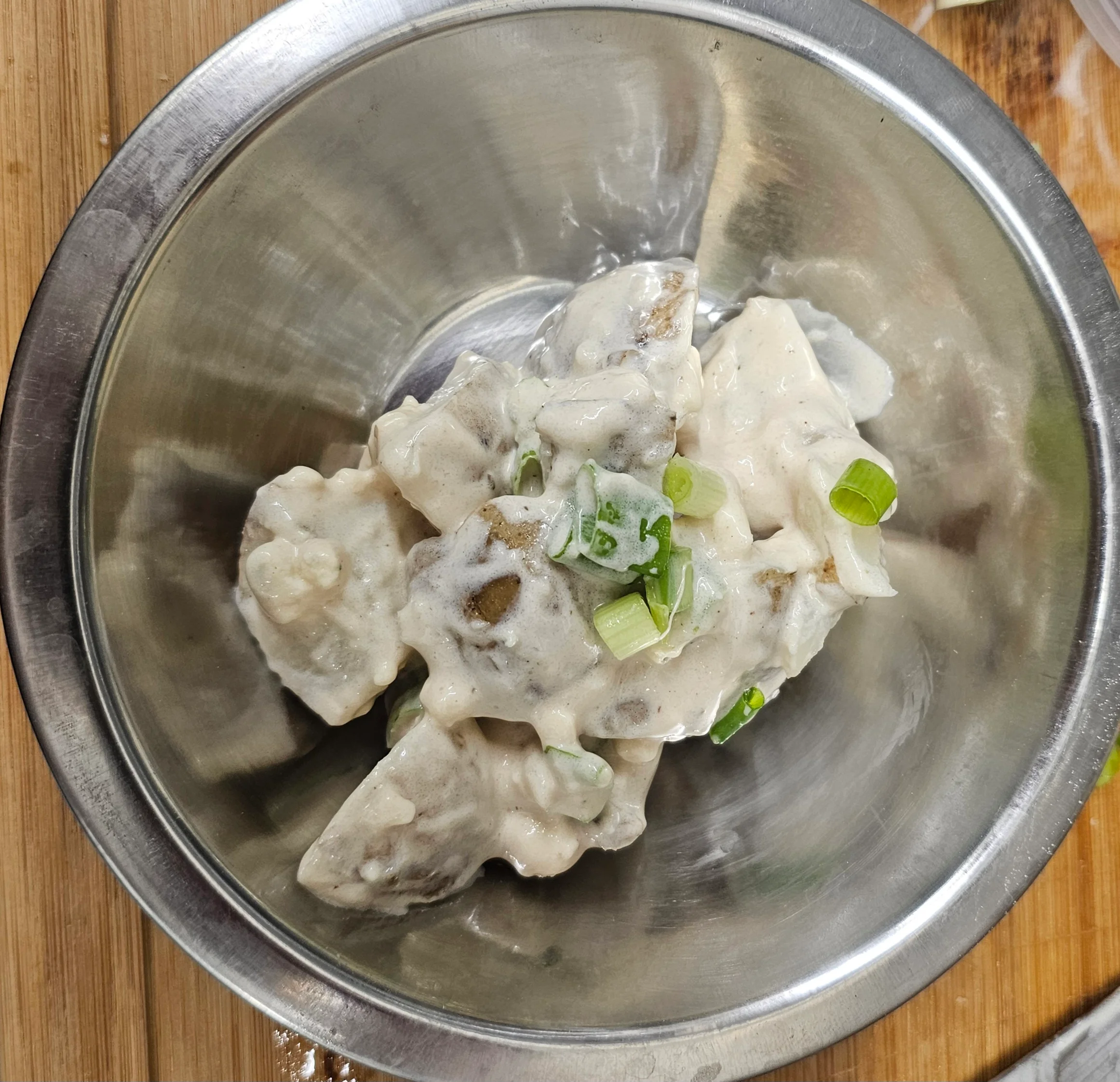 Creamy Russian salad with diced vegetables and herbs