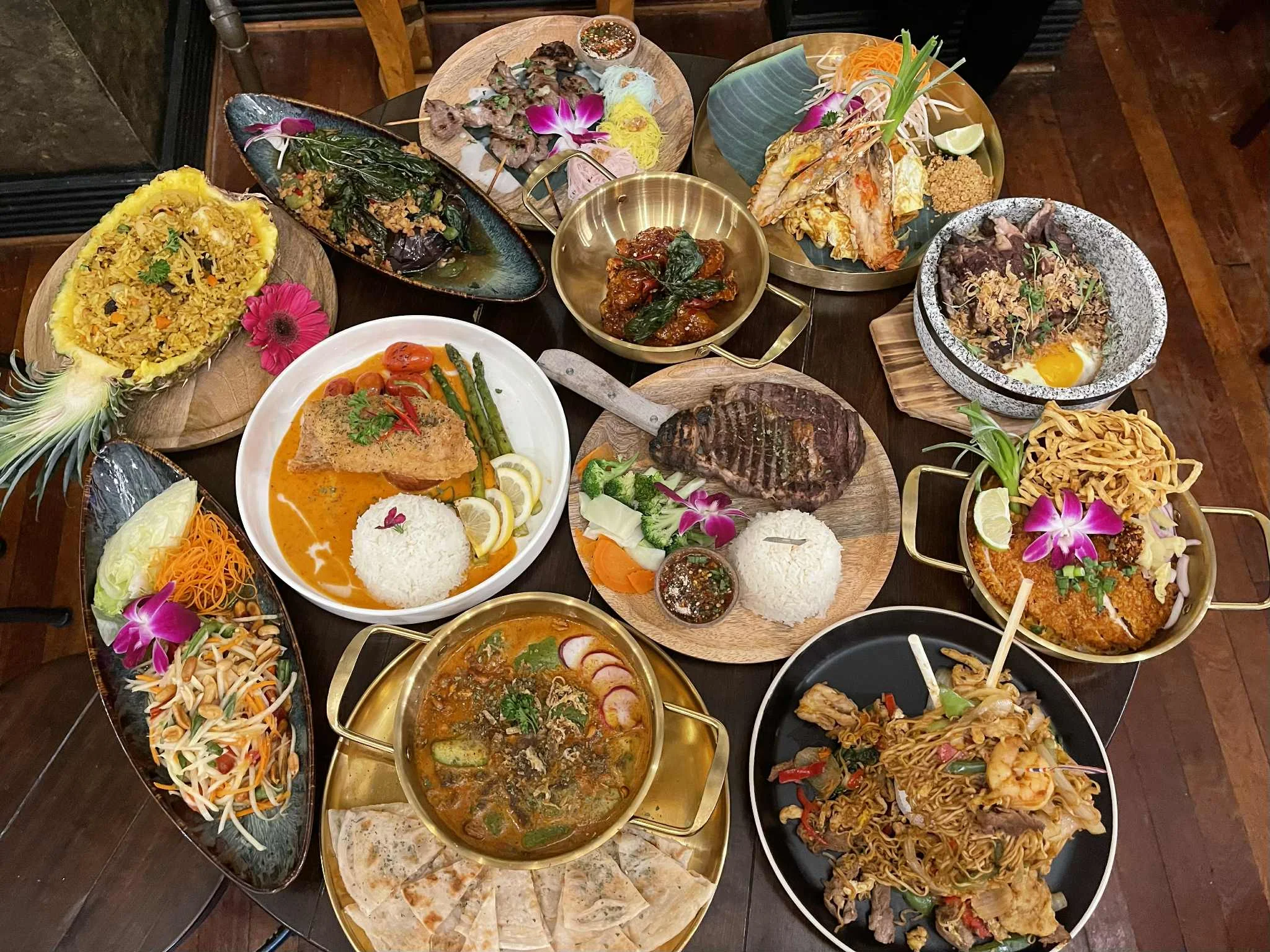 Assorted Southeast Asian dishes on a wooden table