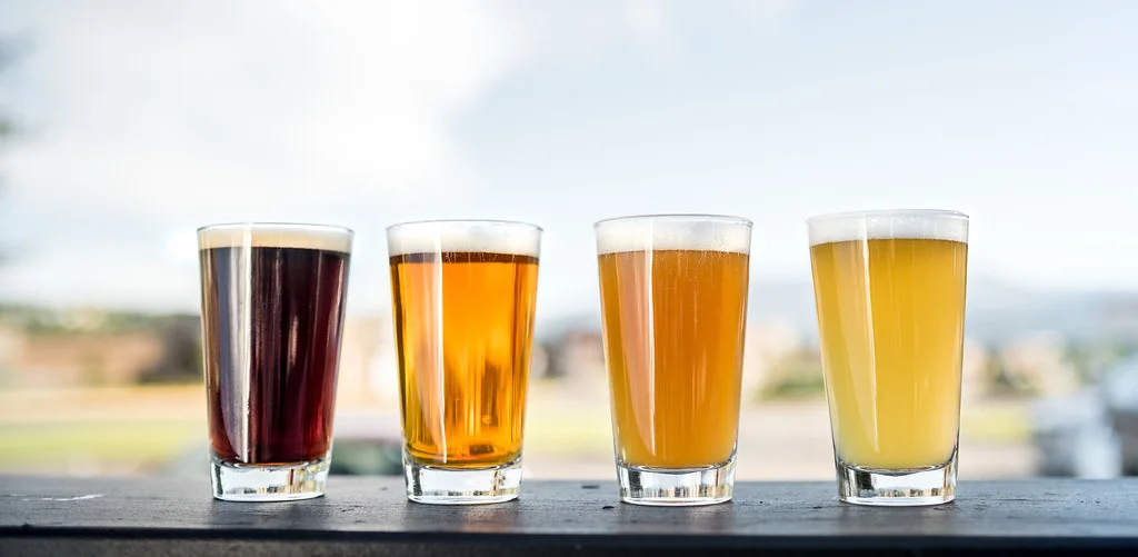 Variety of craft beers in glasses on a sunny patio