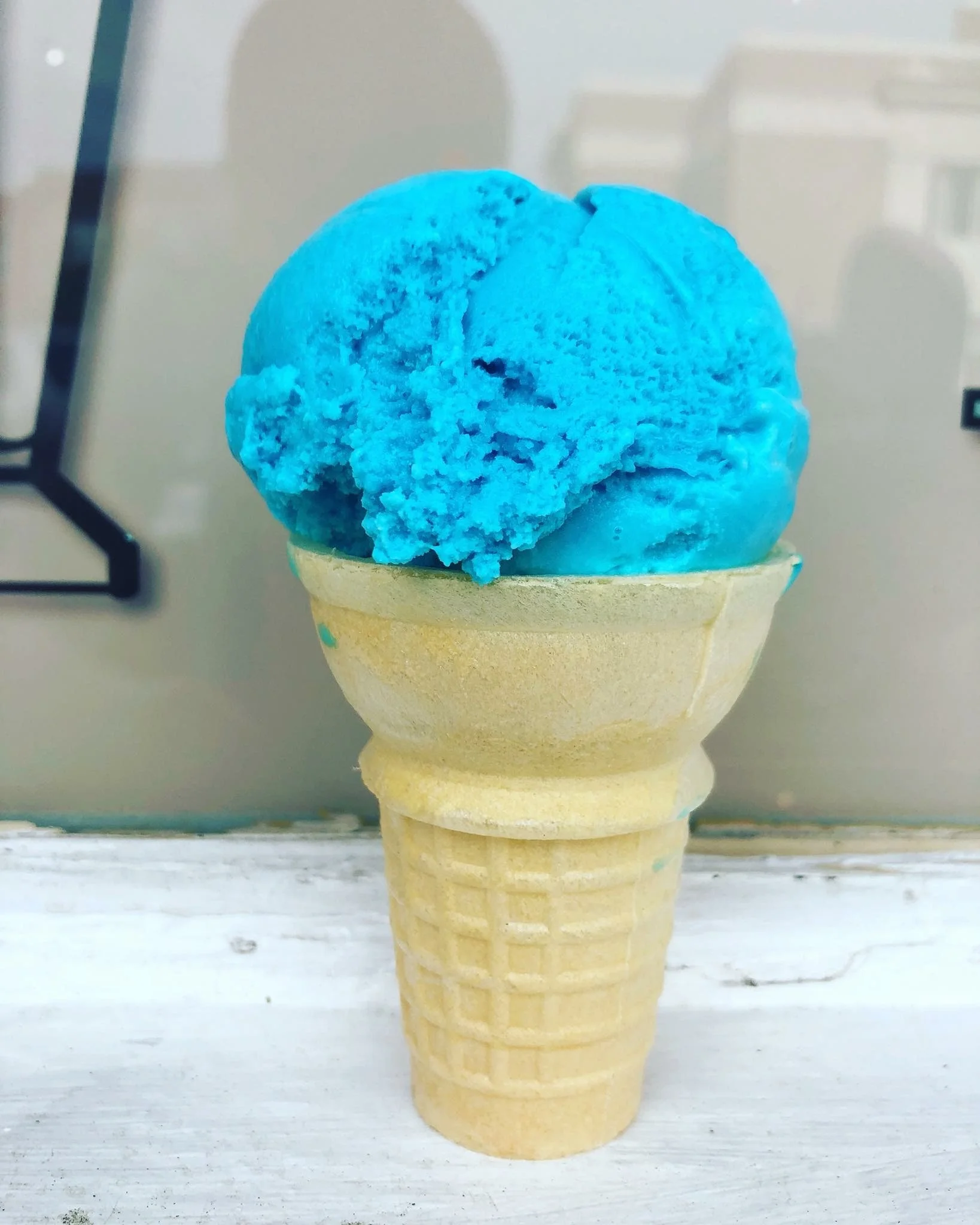 Vibrant blue ice cream in a waffle cone