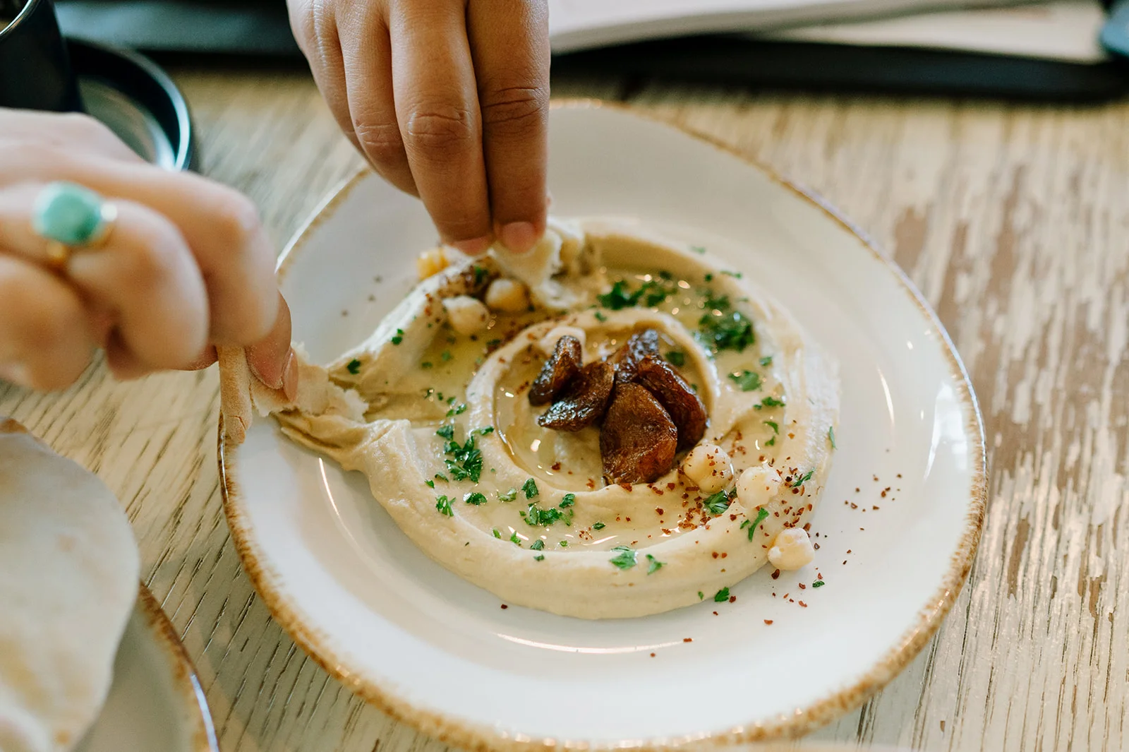 Hummus topped with meat and served with pita at Tripoli's in Alamo Ranch, San Antonio
