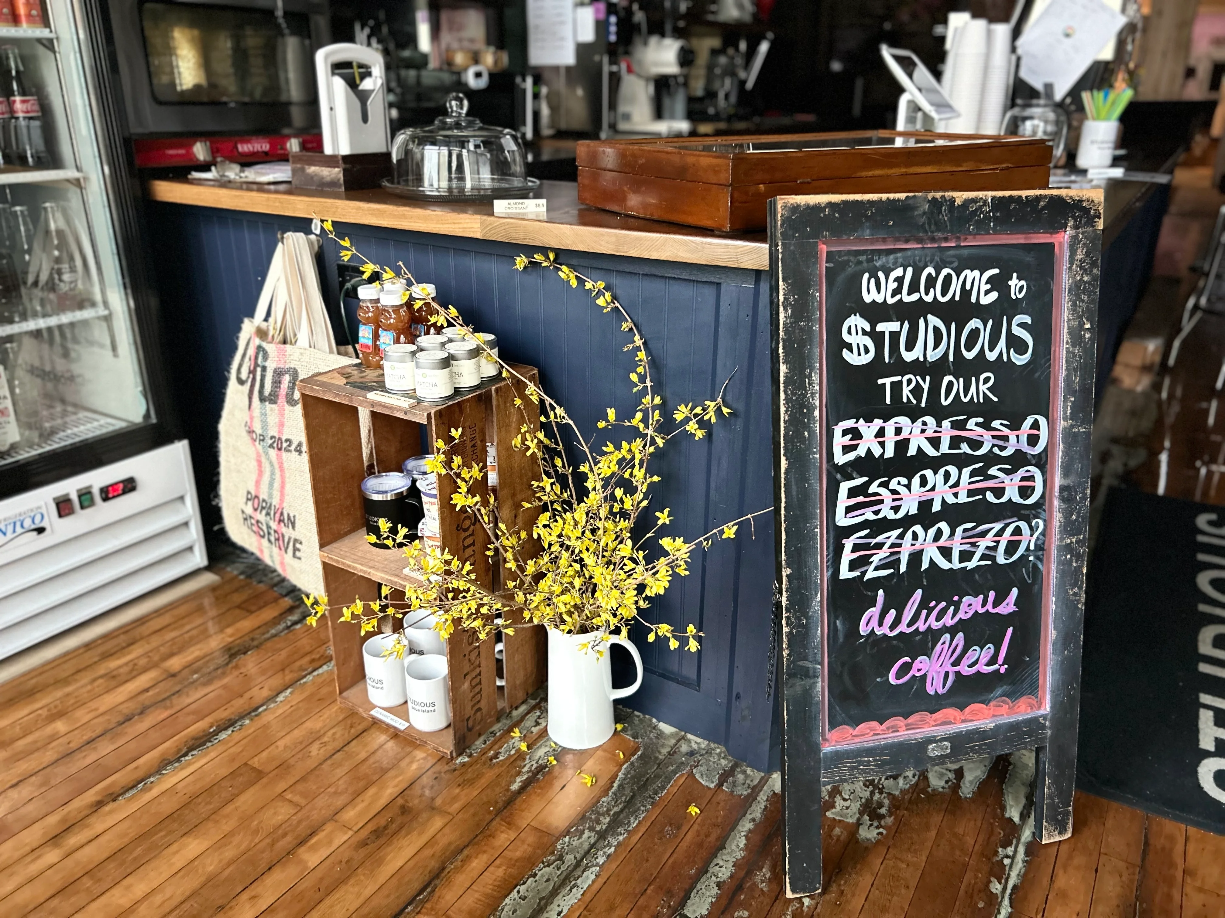 Cozy café entrance with a chalkboard menu and floral decor