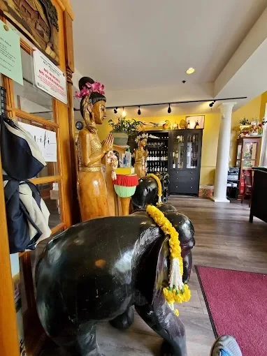 Welcoming restaurant interior with wooden statues and decor