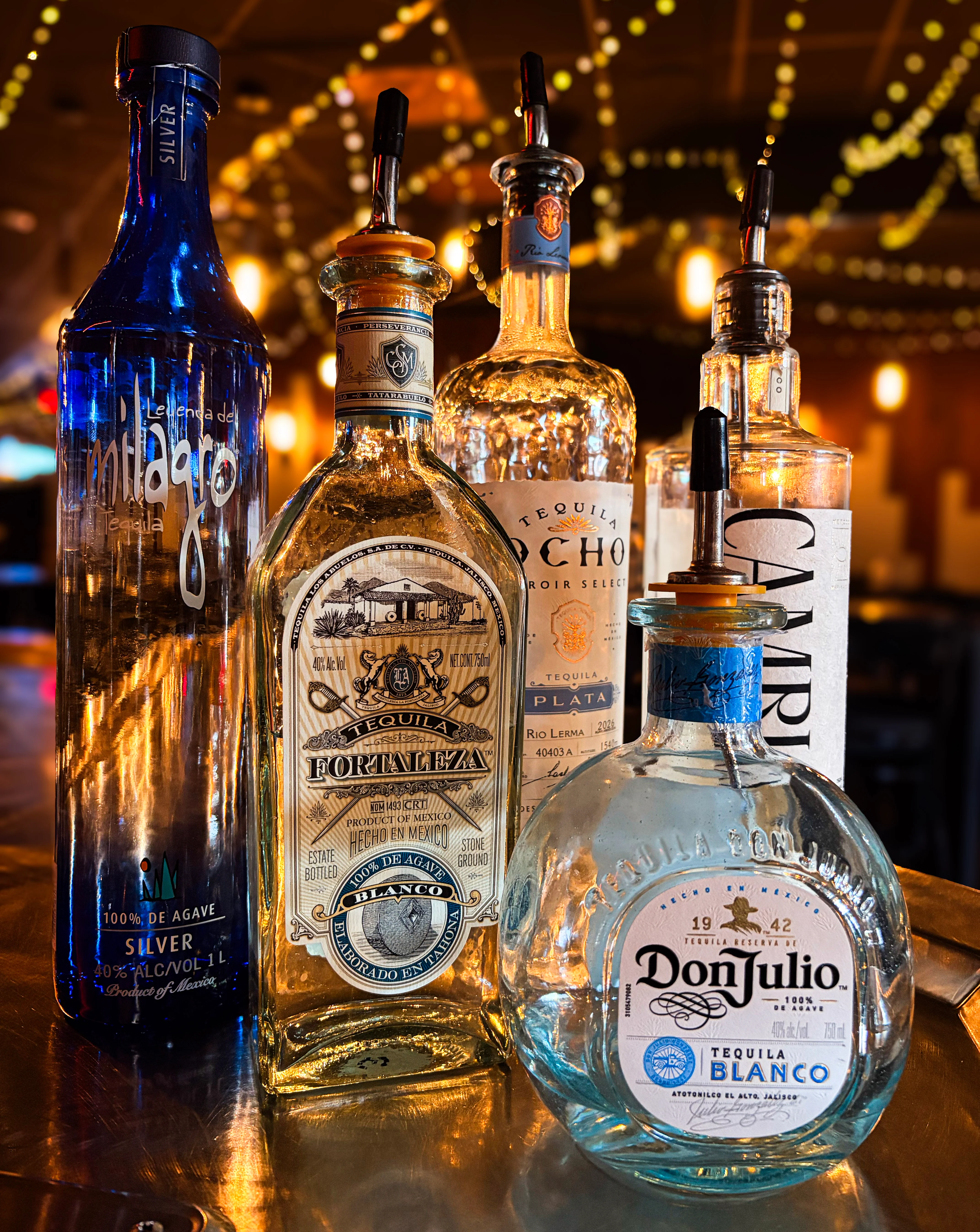 Selection of premium tequila bottles on a bar counter