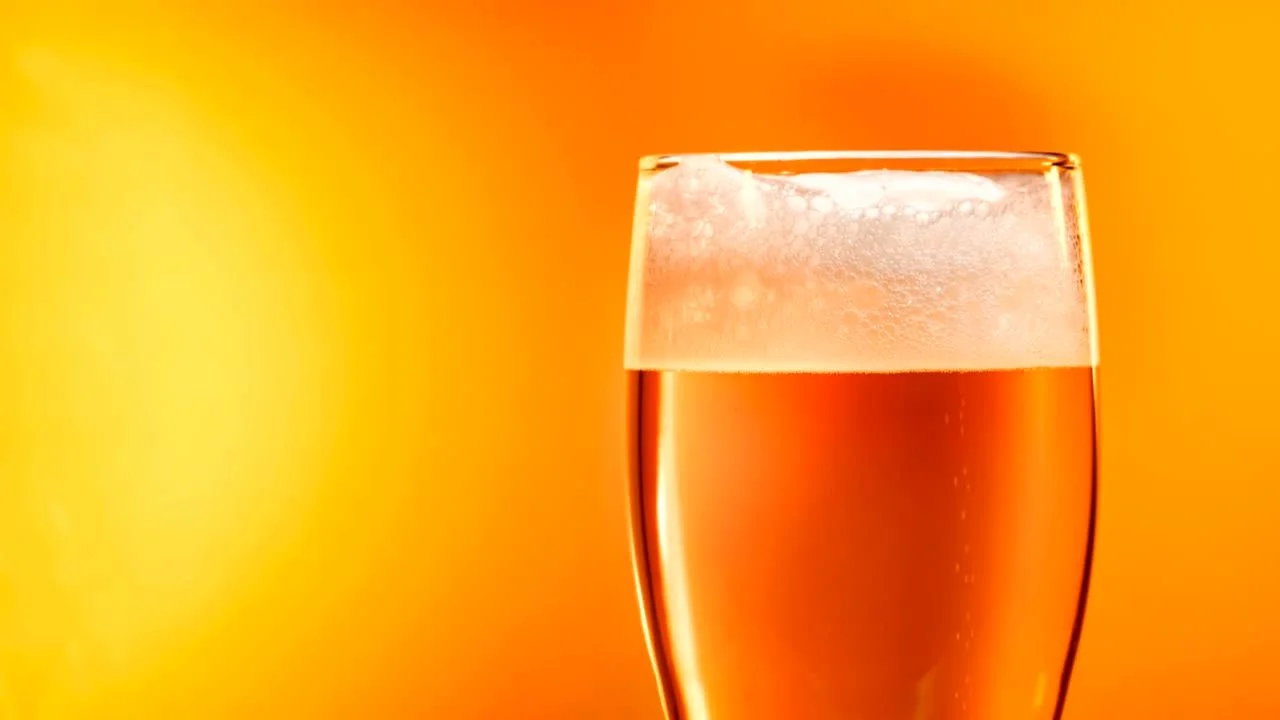 Chilled glass of craft beer with frothy head