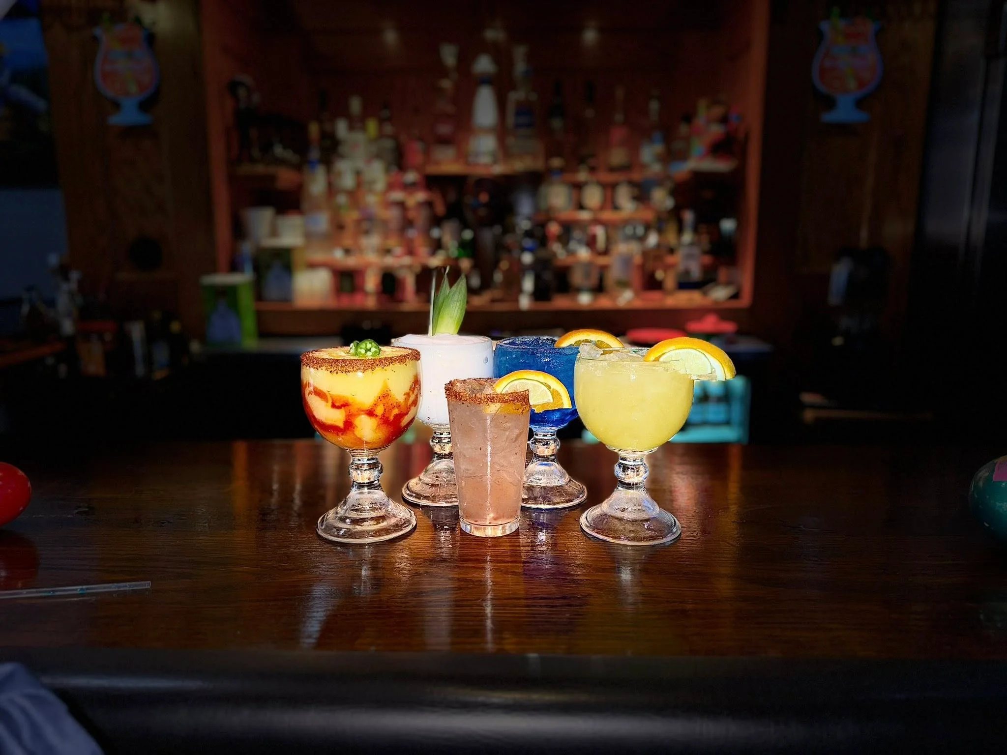 Colorful cocktails displayed on a bar counter