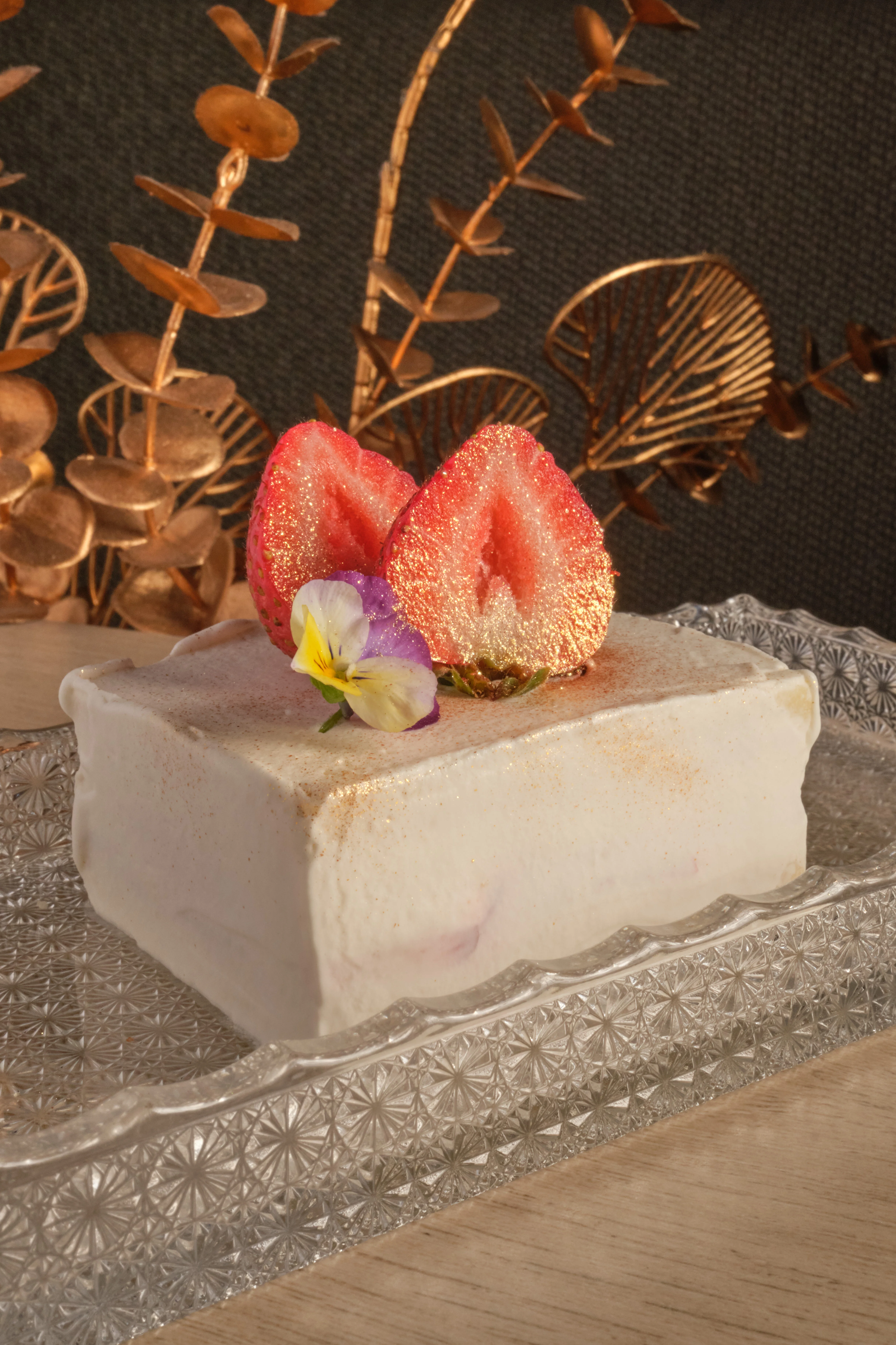 Elegant strawberry mousse cake garnished with edible flowers