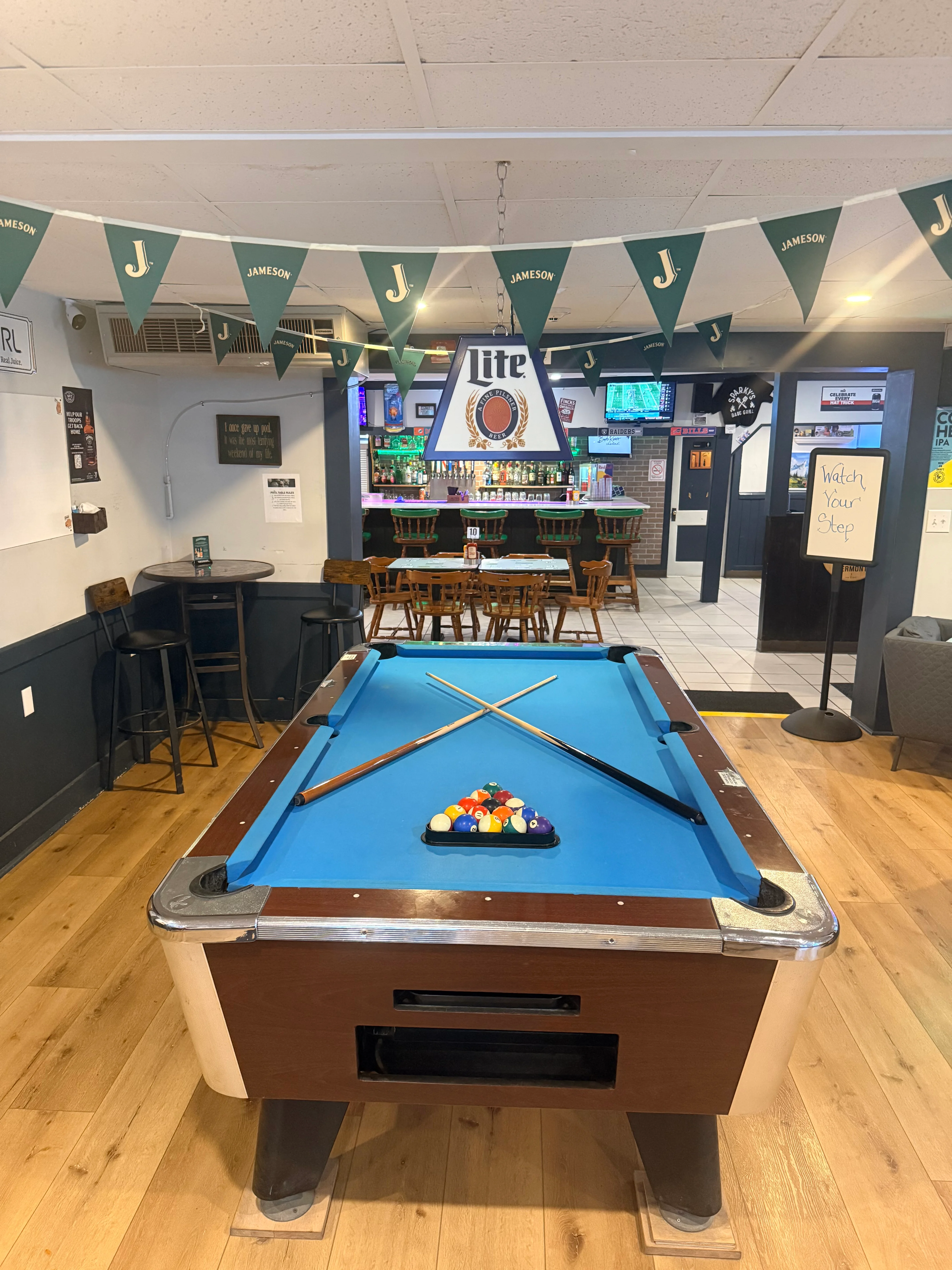 Cozy bar interior with a pool table and drinks