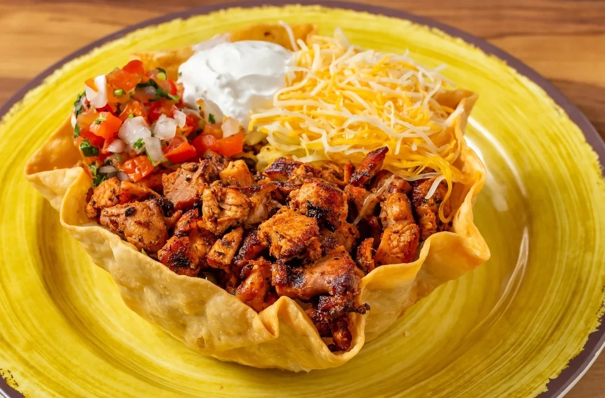 Mexican chicken taco salad in a crispy tortilla bowl