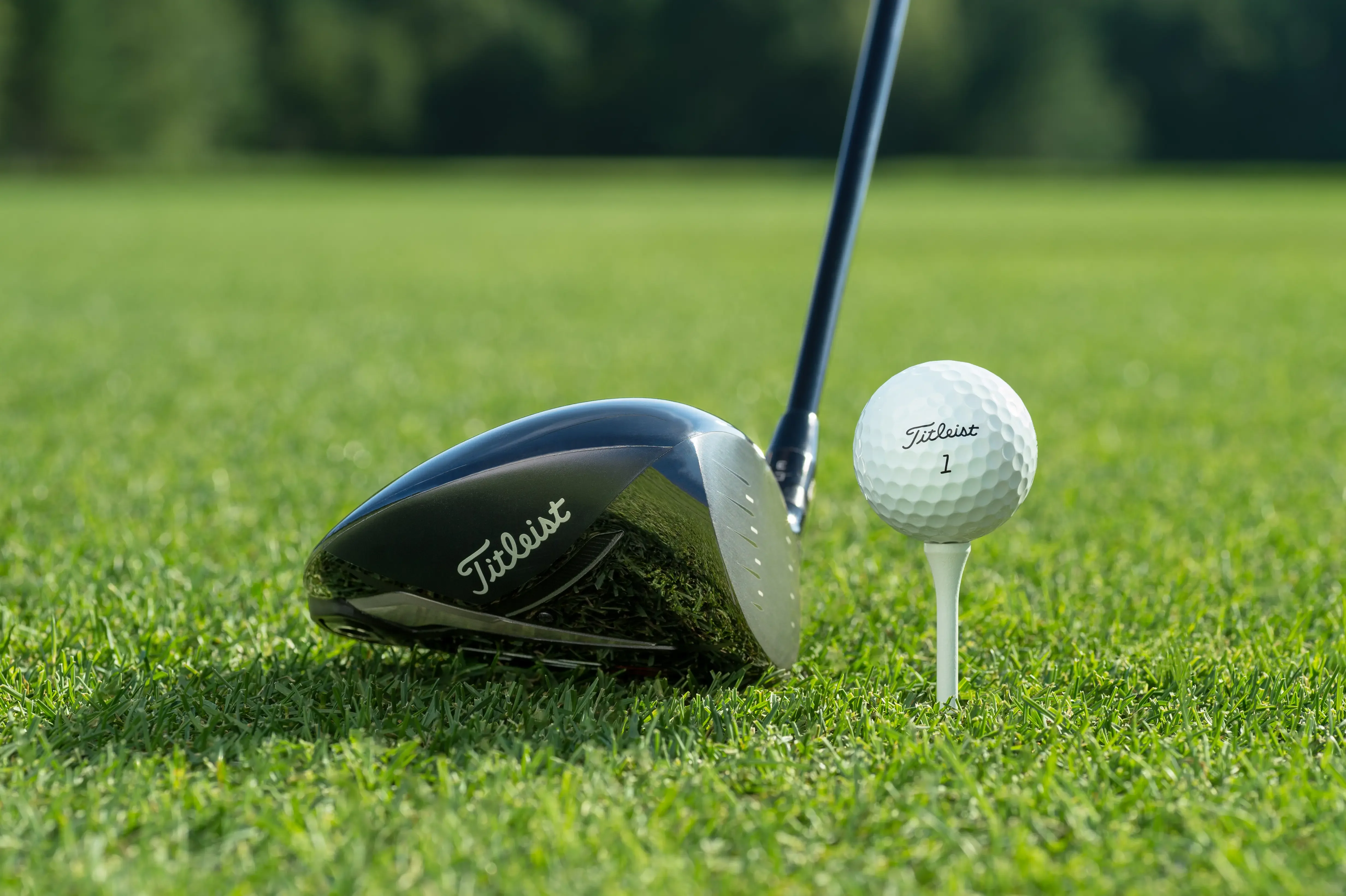 Golf driver and ball on a lush green fairway