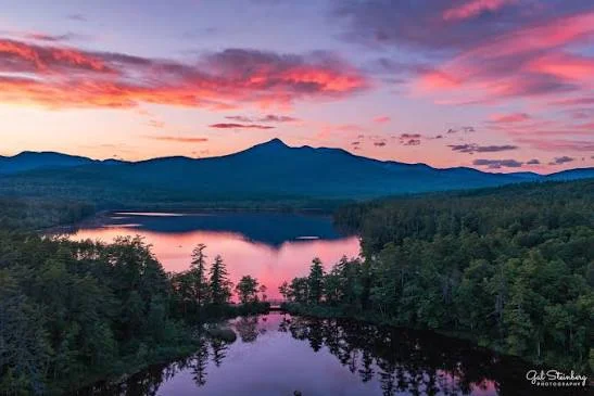 Scenic sunset over a tranquil lake and mountains