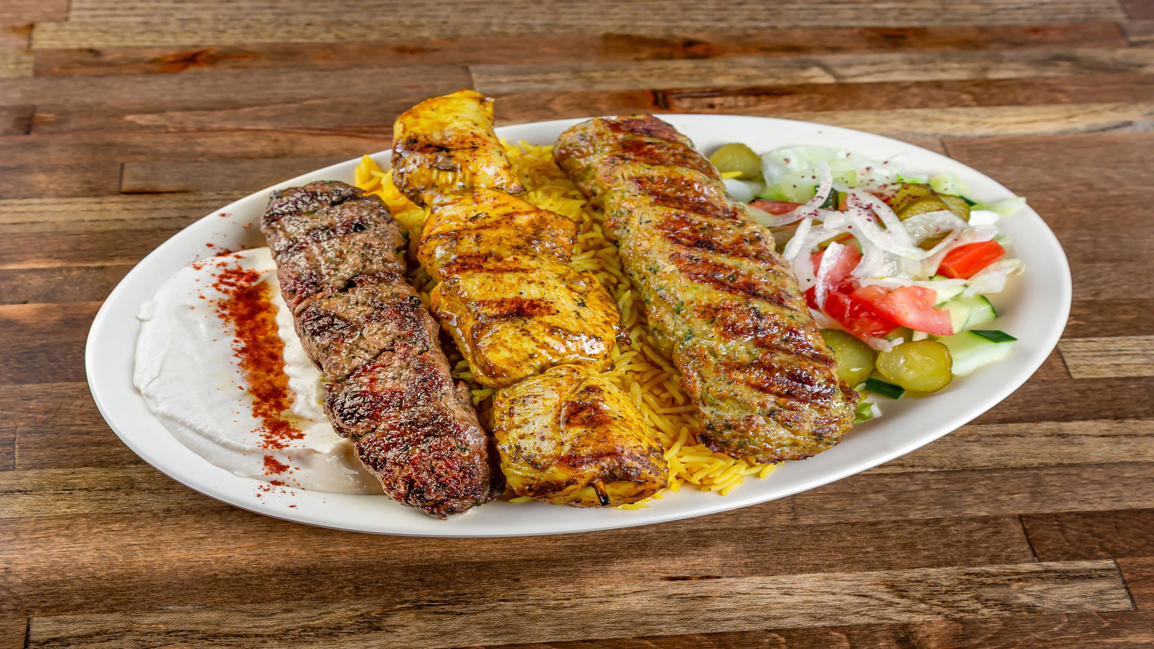 Pita Zone mixed kabab plate with rice, hummus and salad