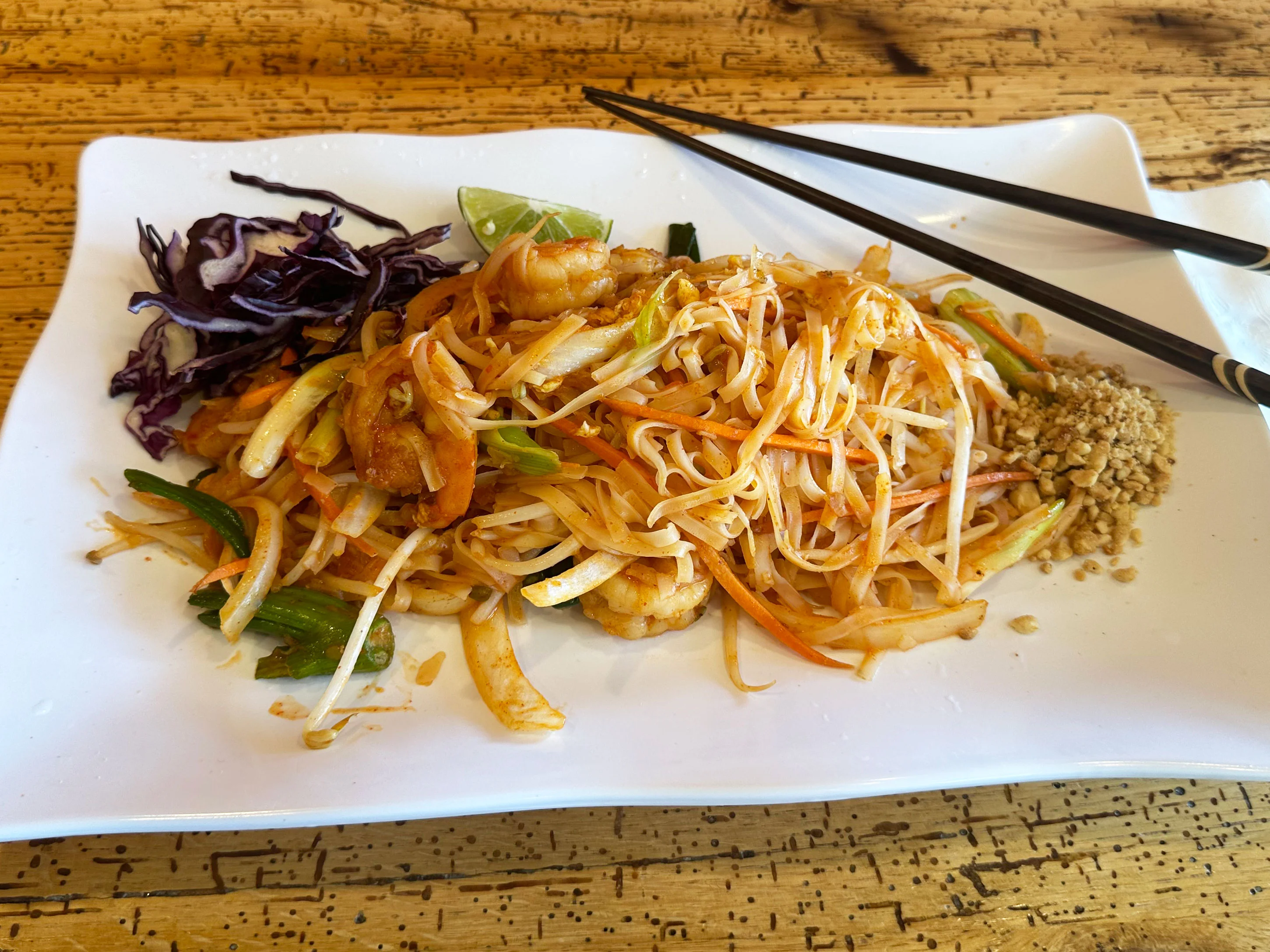 Plate of Thai pad thai with shrimp and vegetables