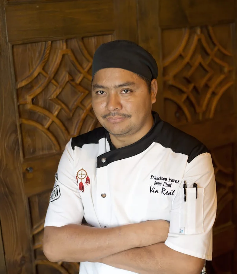 Chef posing confidently in a restaurant kitchen