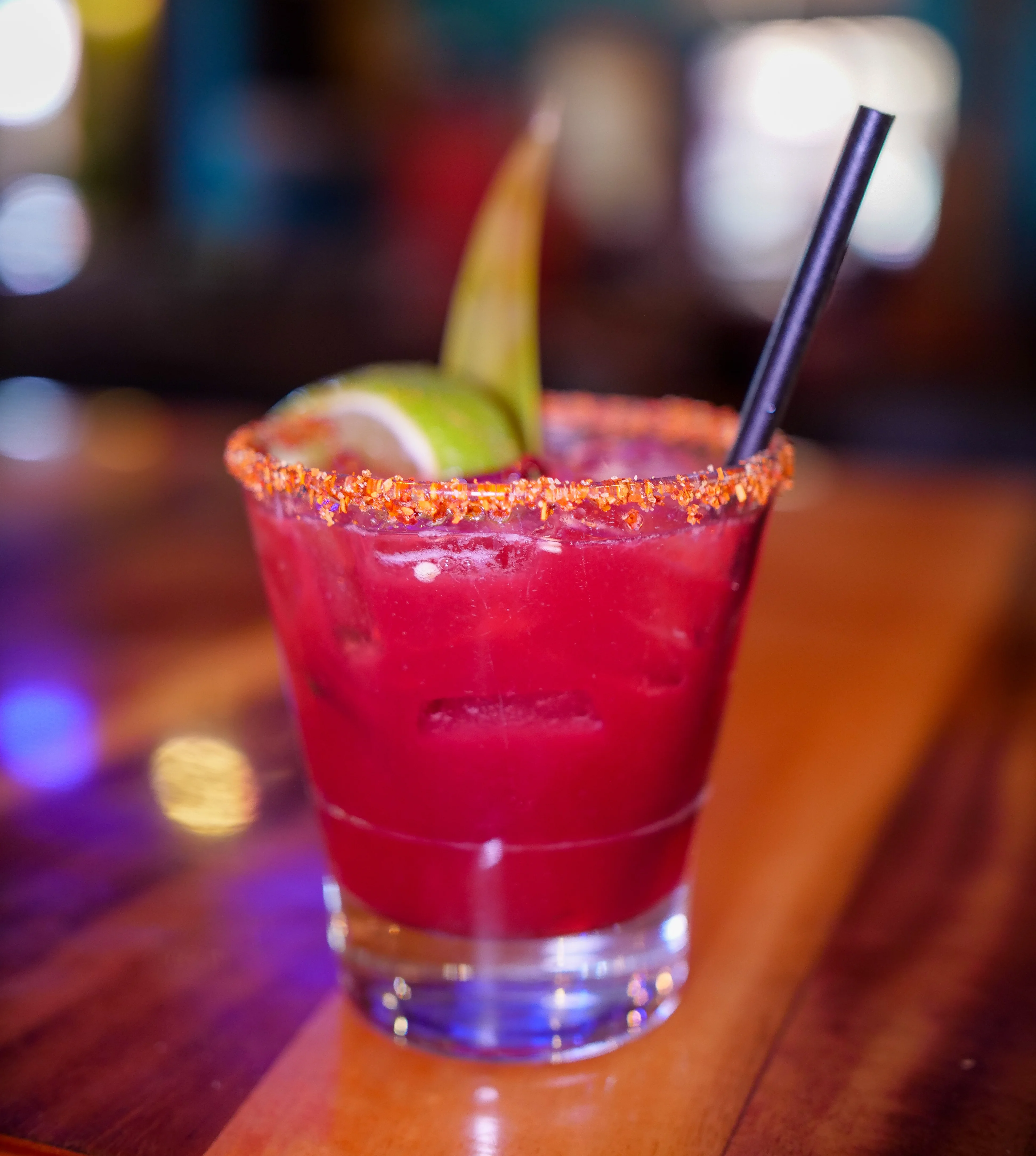 Vibrant Mexican cocktail with lime and chili rim