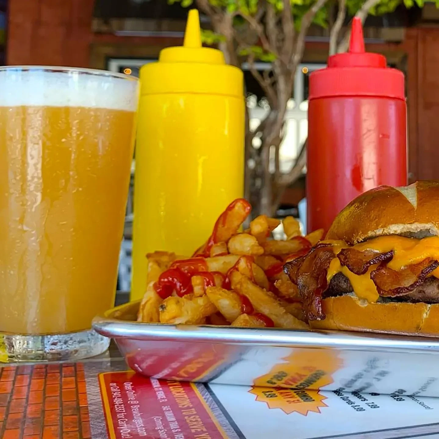 Juicy cheeseburger with fries and craft beer