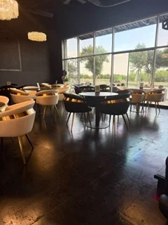 Modern restaurant interior with stylish seating and large windows