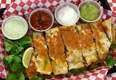 Crispy quesadilla served with salsas and sour cream