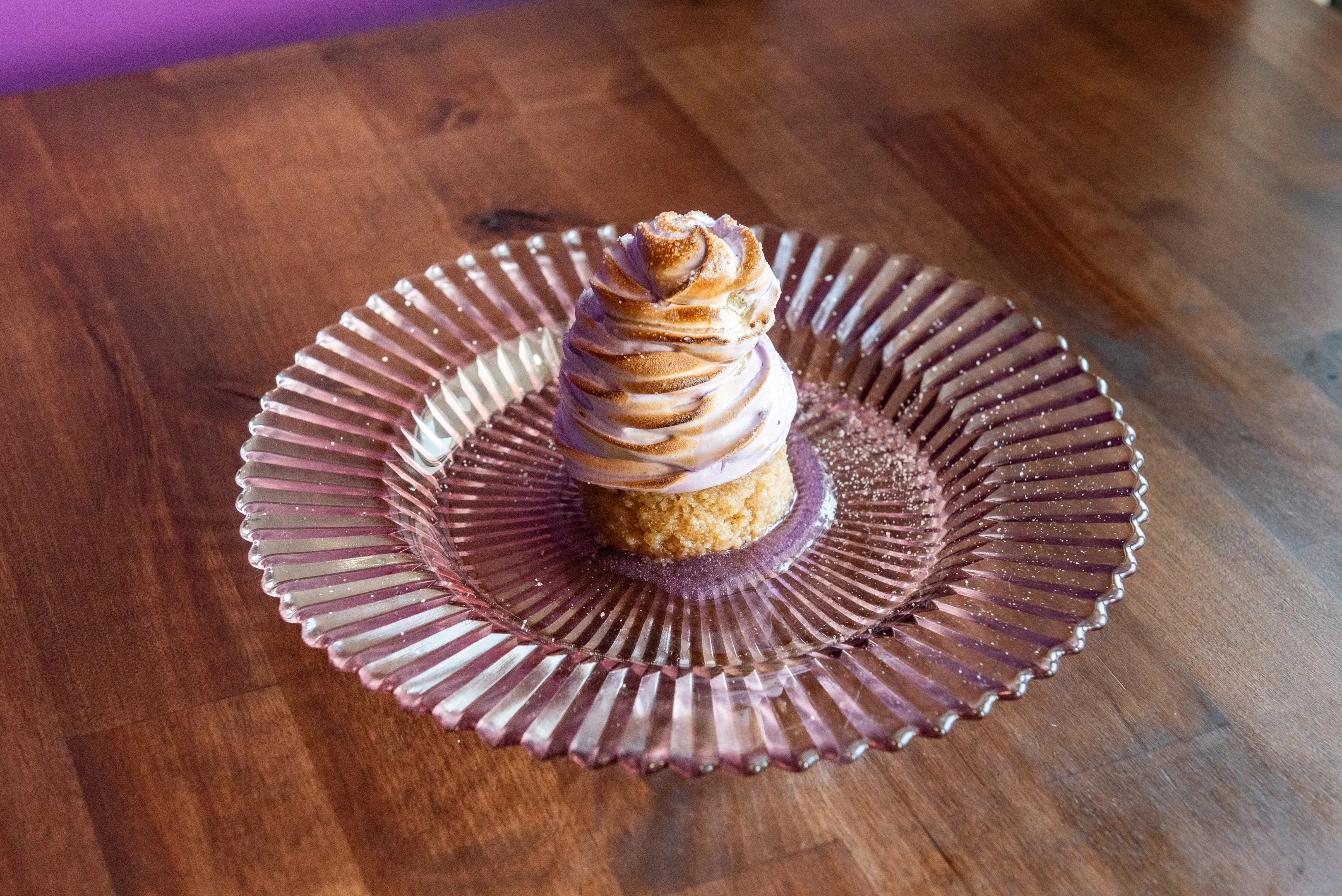 Delicious pie with a golden crust and fruit filling on a wooden table.