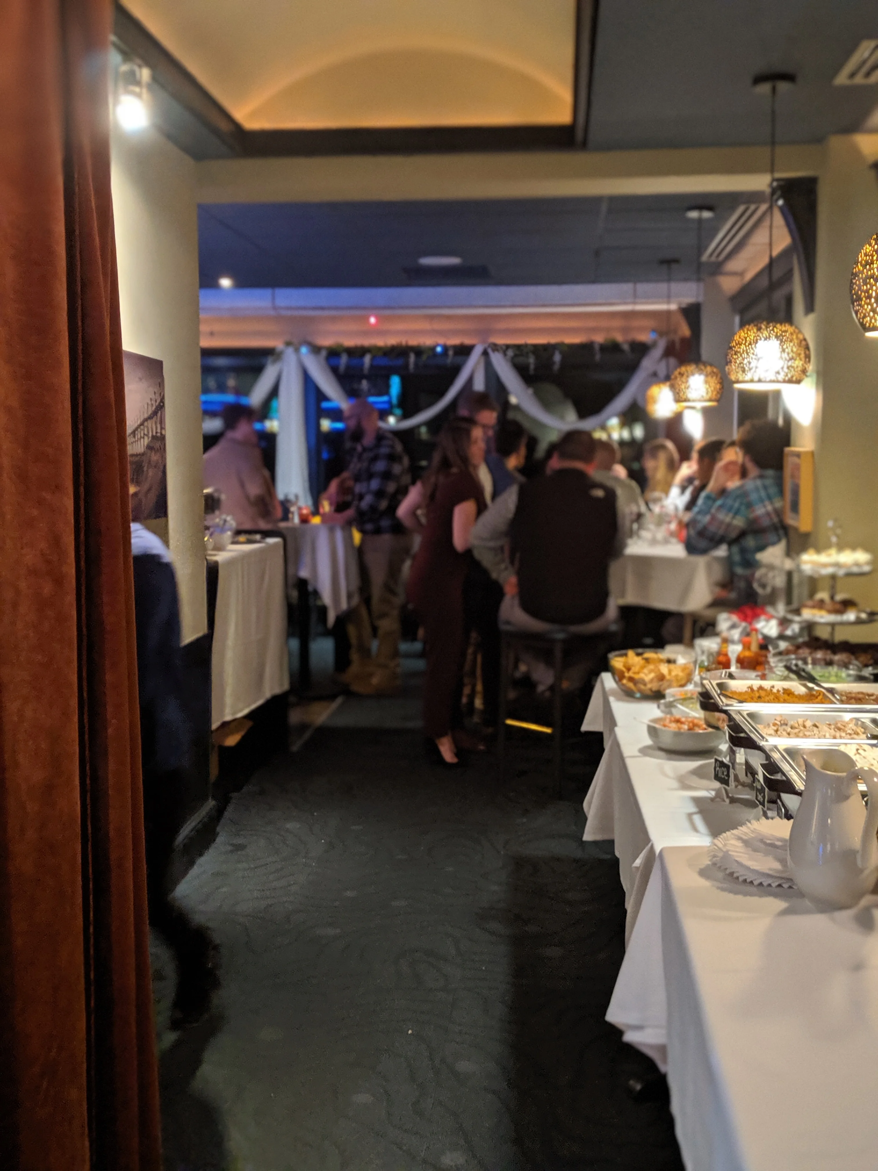 Cozy restaurant interior with guests enjoying a lively atmosphere