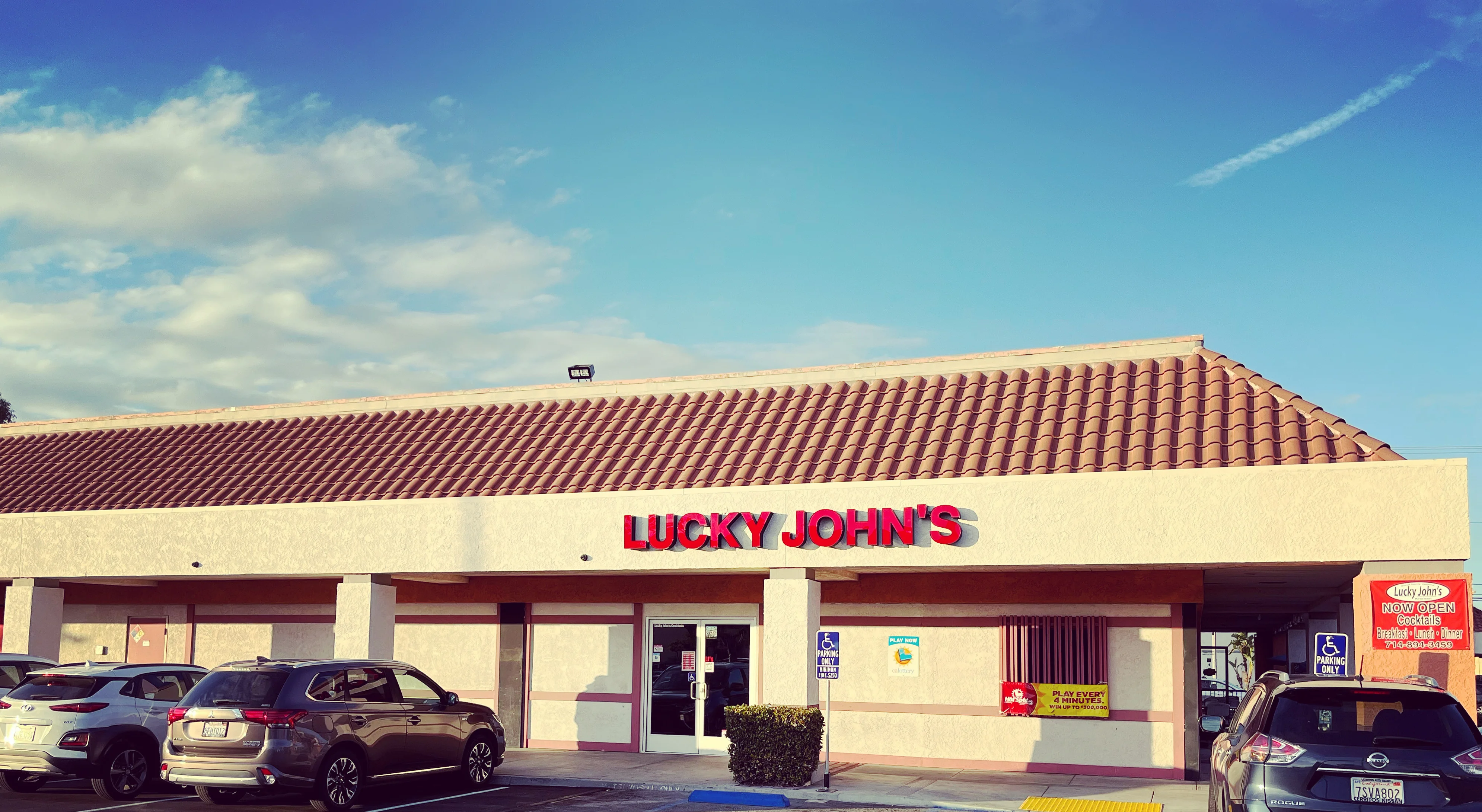 Exterior view of Lucky John's restaurant with signage and parking area