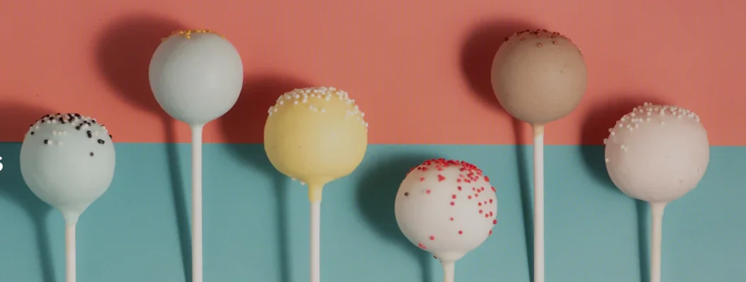Colorful cake pops arranged on a vibrant background