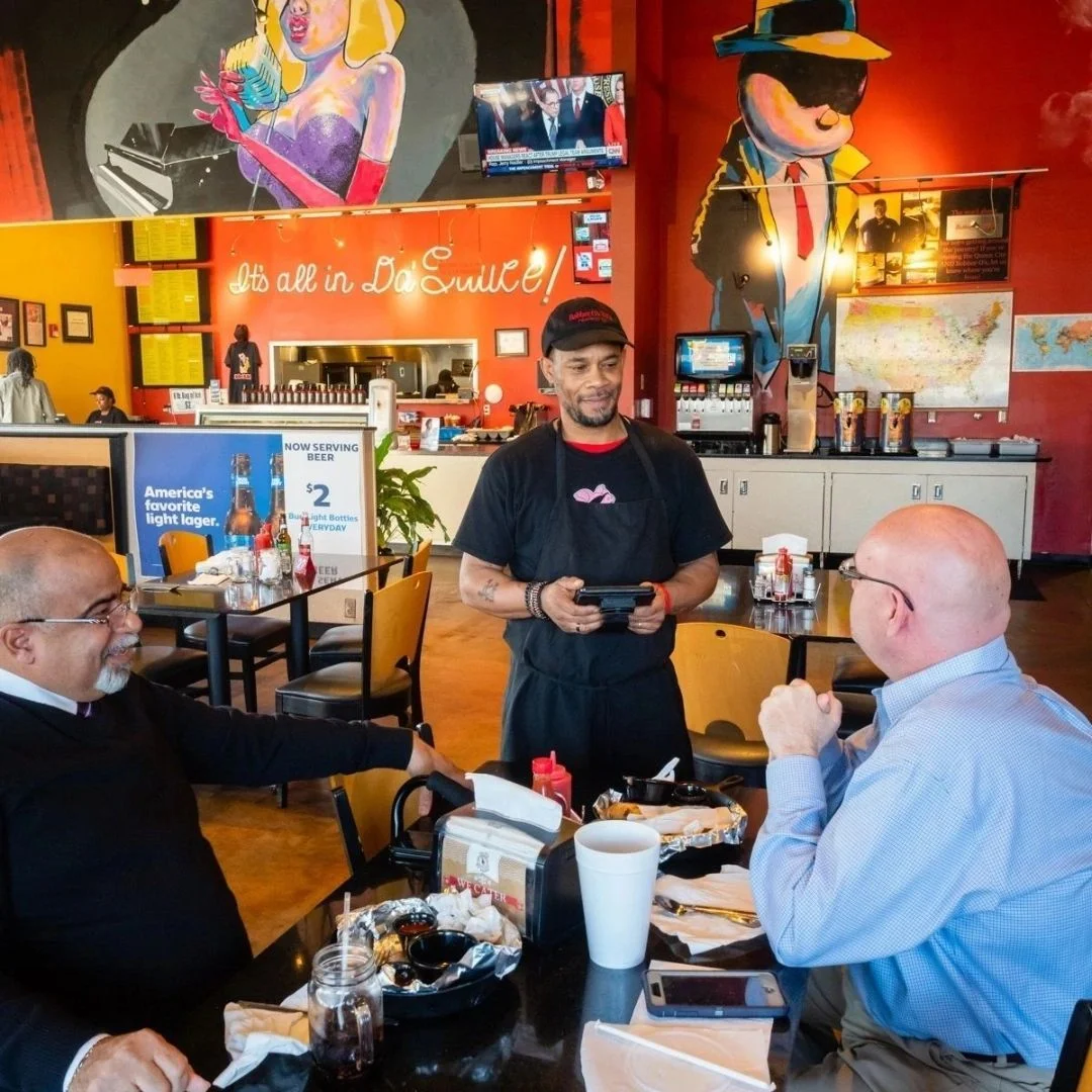 Vibrant restaurant interior with diners and a friendly server