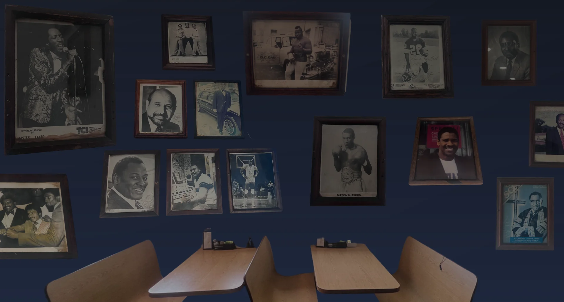 Restaurant dining room with framed historical portraits and wooden tables