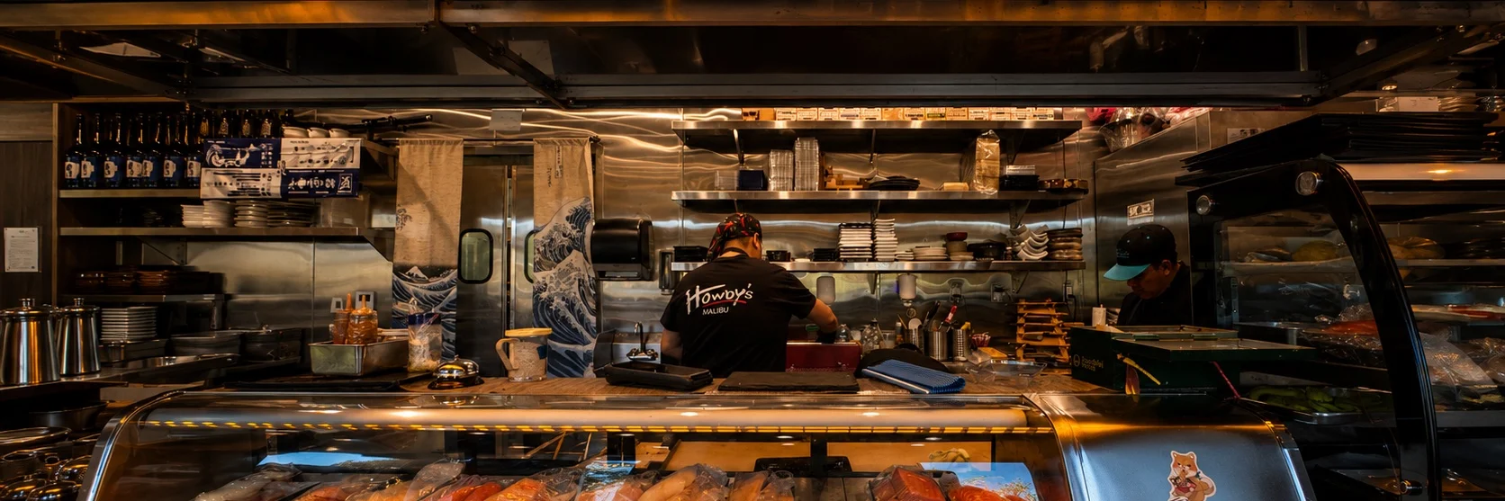 The Malibu Sushi bar — the chef at work behind the counter, fresh fish in the case