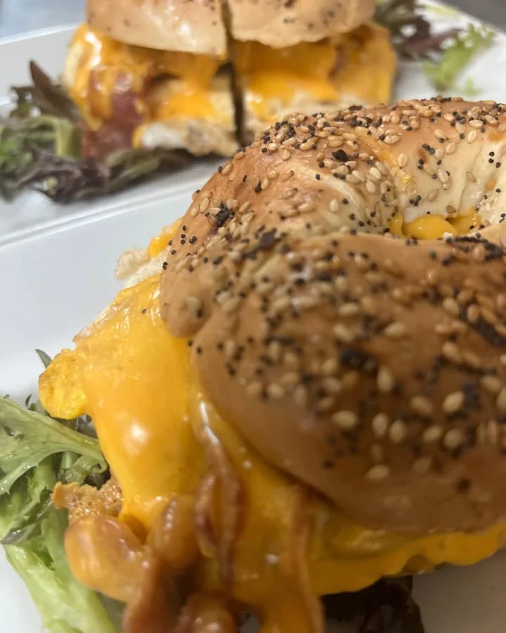 Cheddar bagel sandwich with bacon and egg