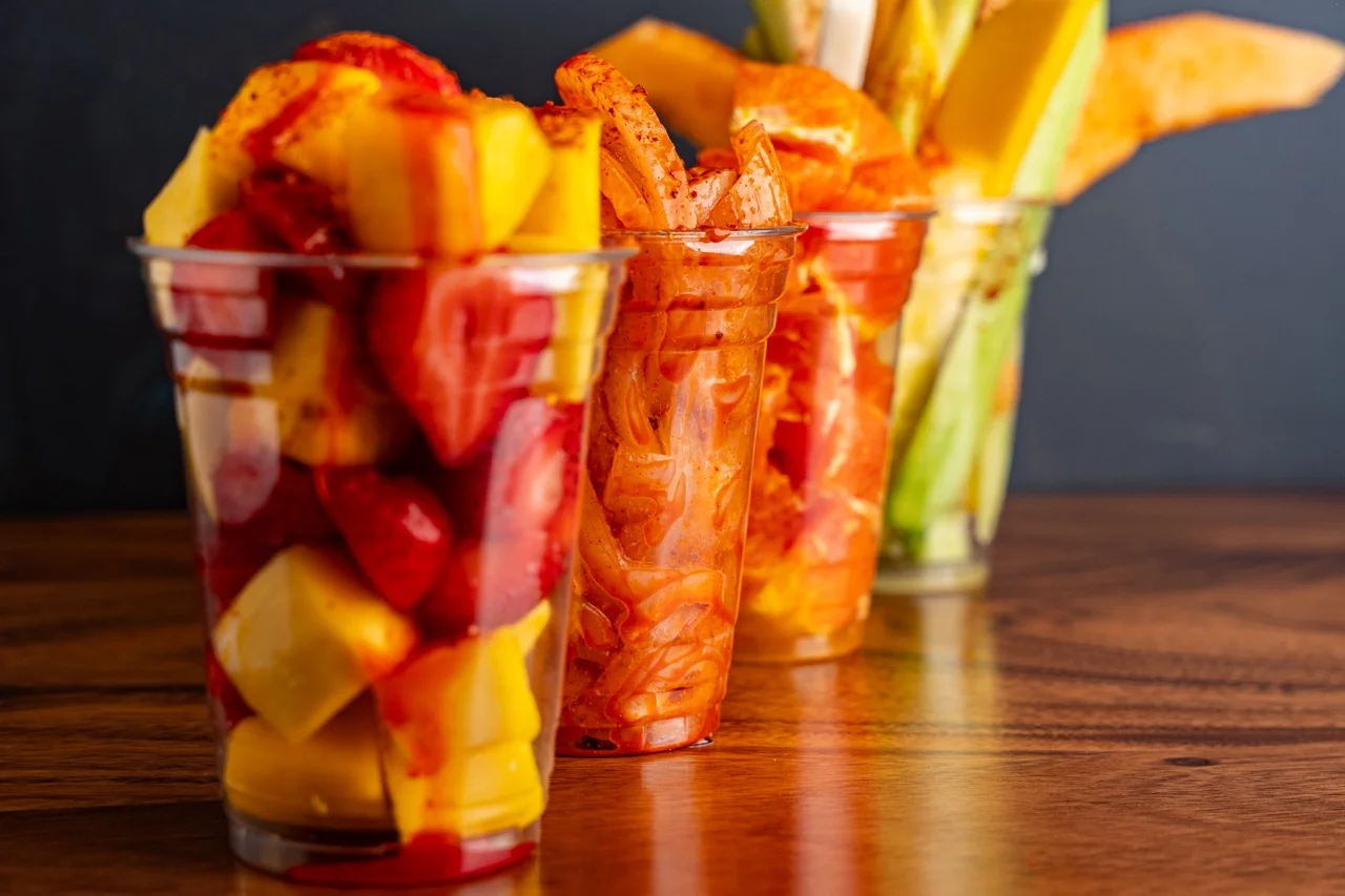 Colorful Mexican fruit cups with chili and lime