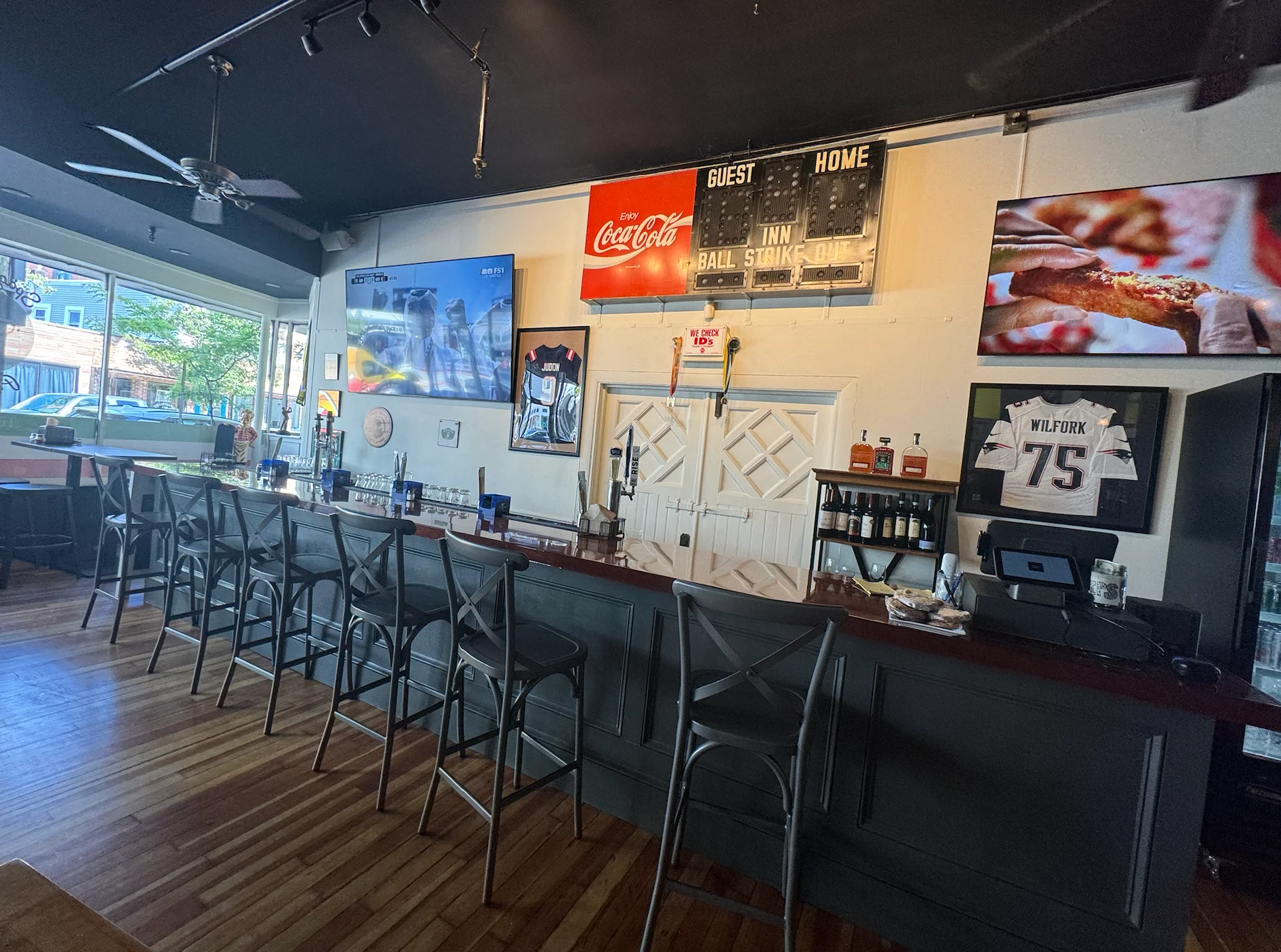 Modern bar interior with seating and TVs