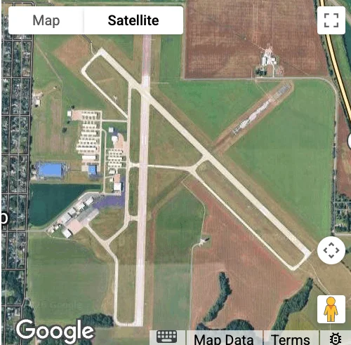 Aerial view of a regional airport with runways and facilities