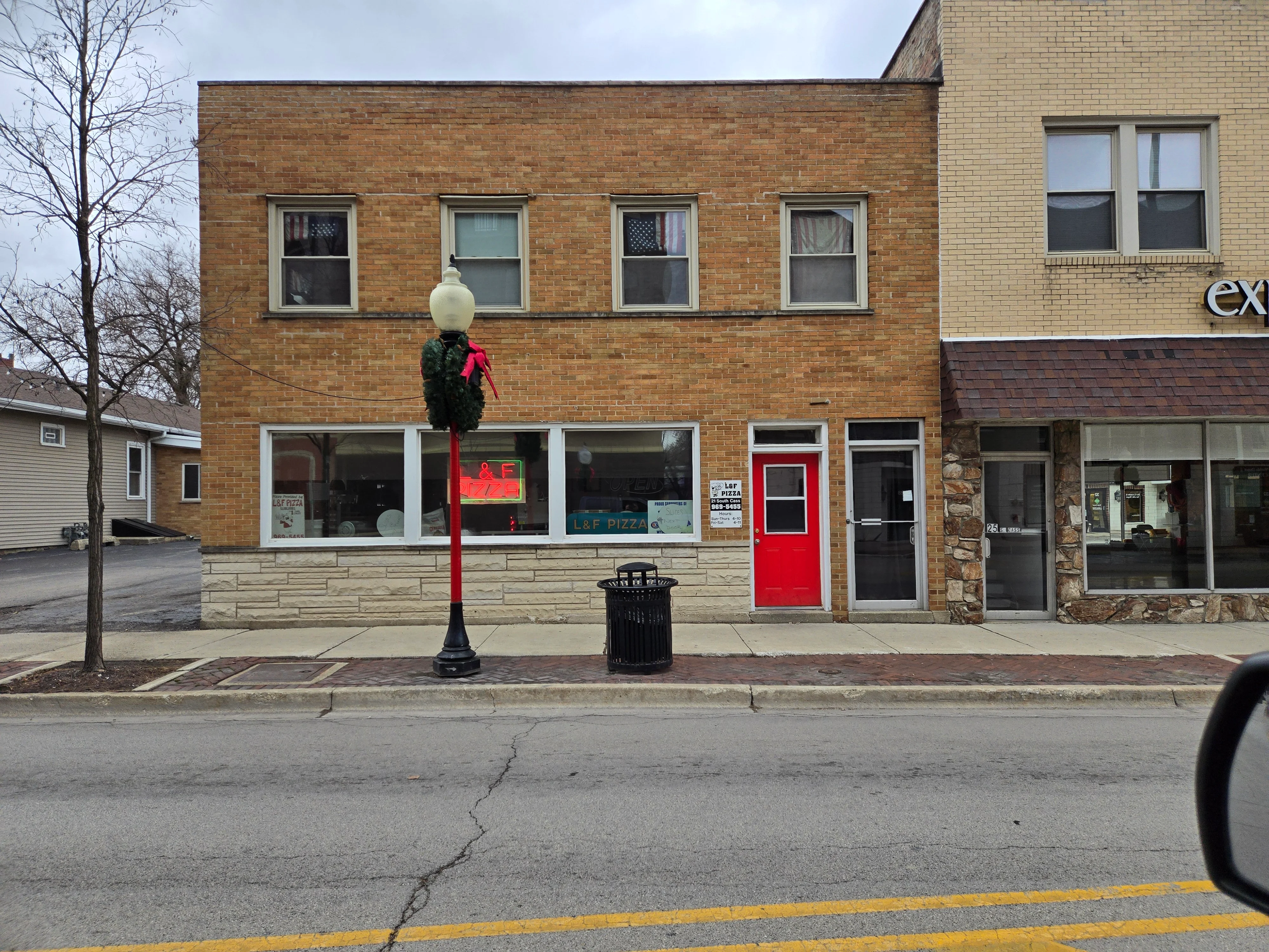 Exterior view of L&F Pizza restaurant with festive decor