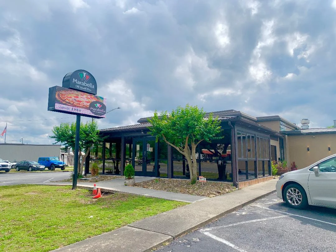 Exterior view of Marabella restaurant with a digital sign
