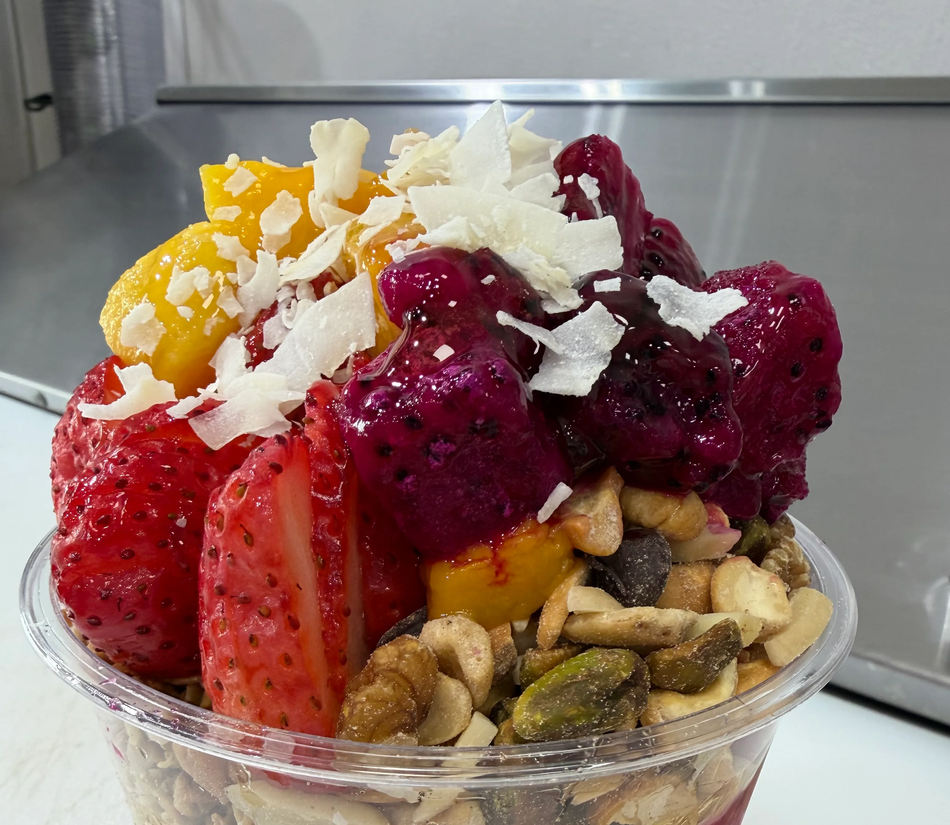 Colorful acai bowl topped with fresh fruits and coconut flakes