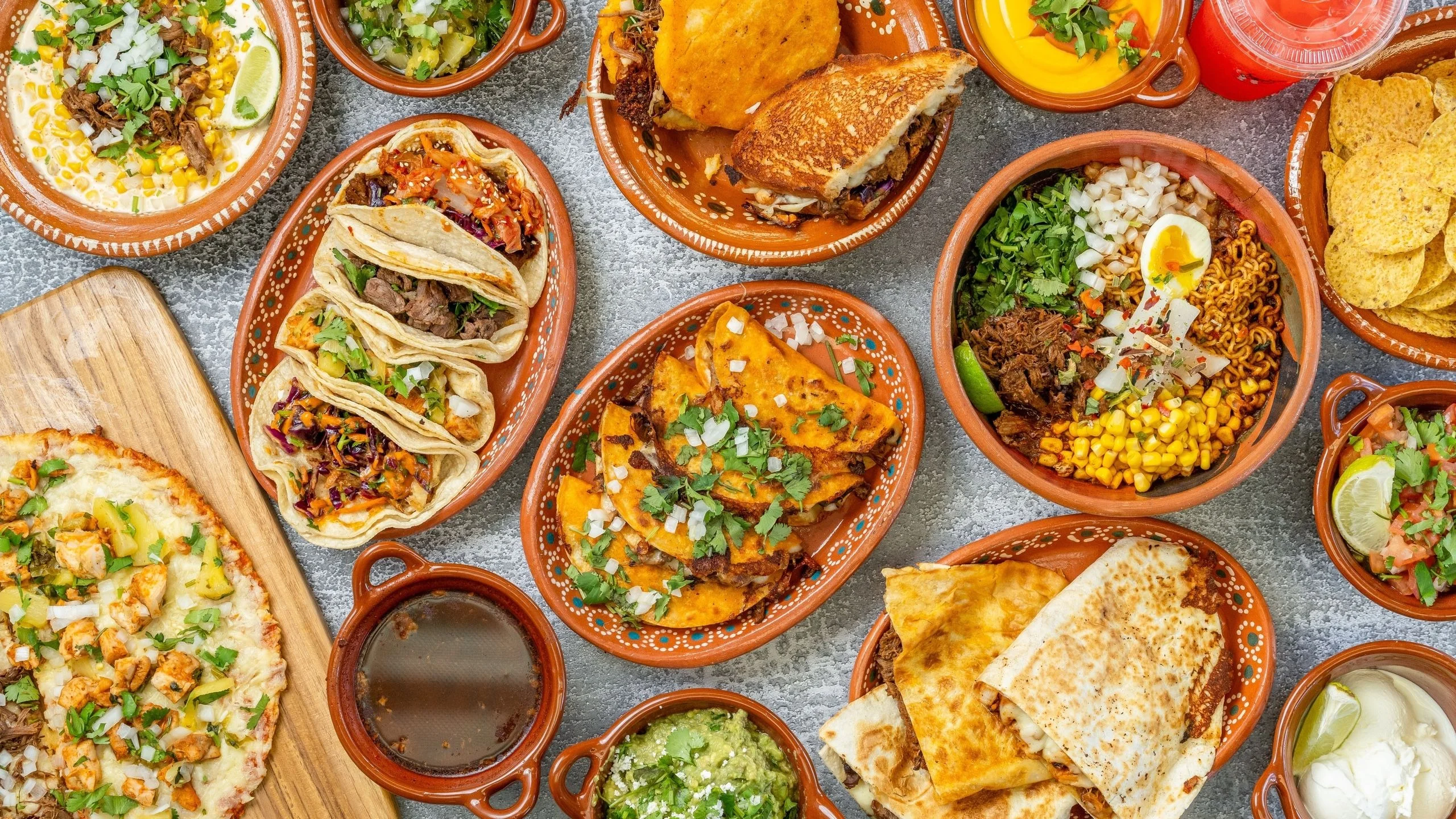 Colorful Mexican feast with tacos, quesadillas, and guacamole