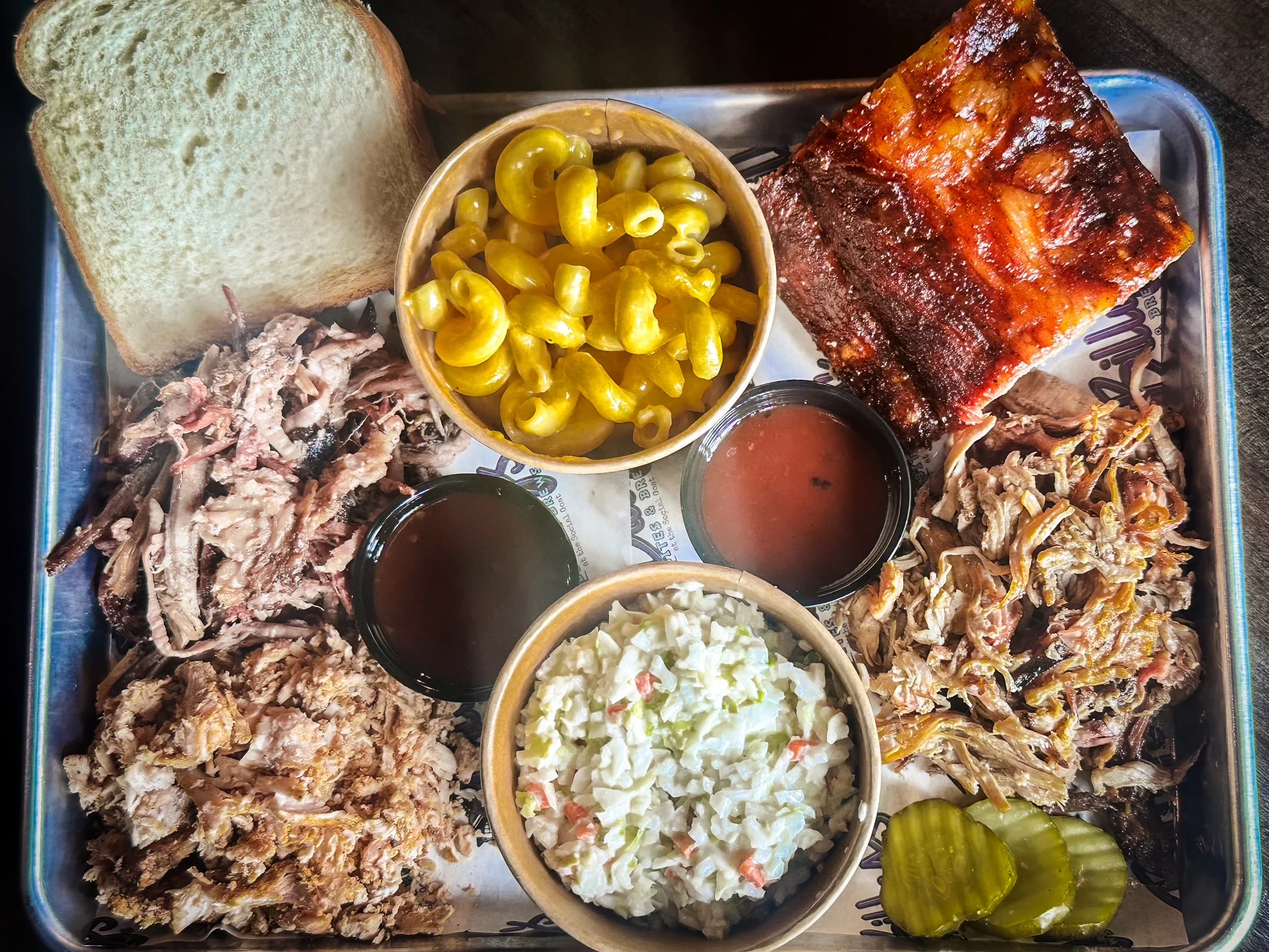Southern barbecue platter with pulled pork, ribs, and sides