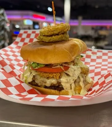 Delicious gourmet burger with fresh toppings on a wooden table