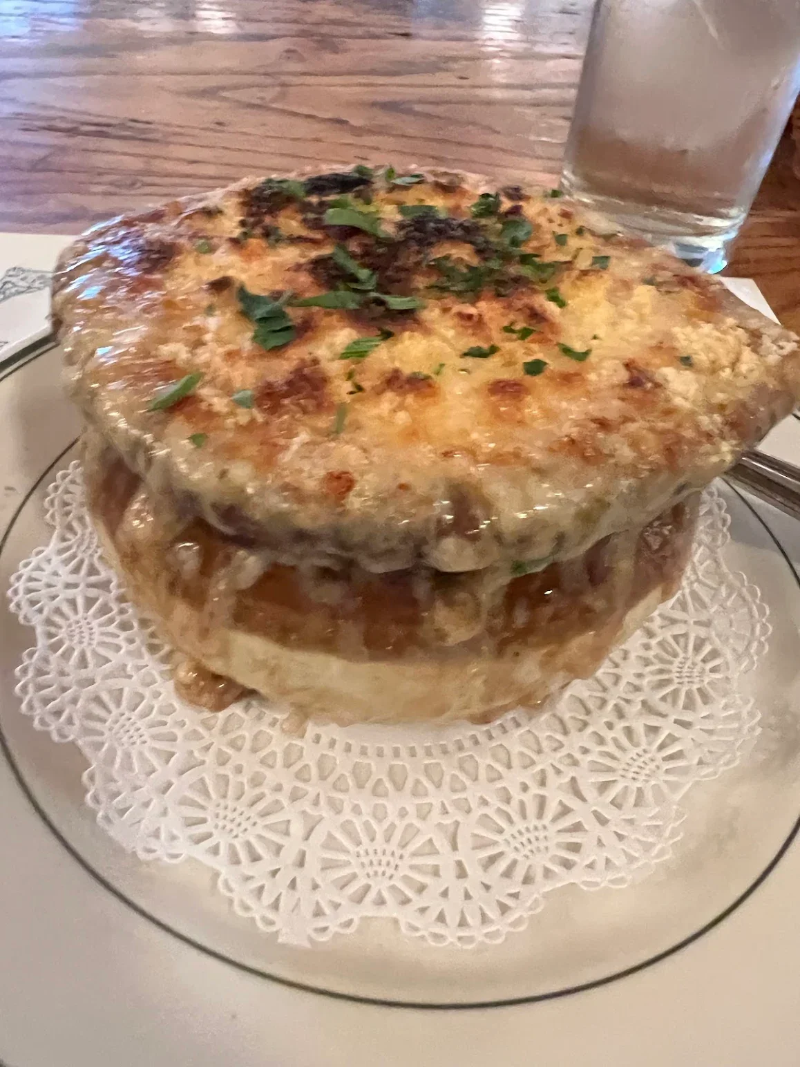 French onion soup topped with melted cheese and herbs