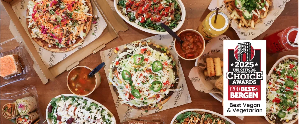 Table spread of flatbreads, bowls, burgers, and more