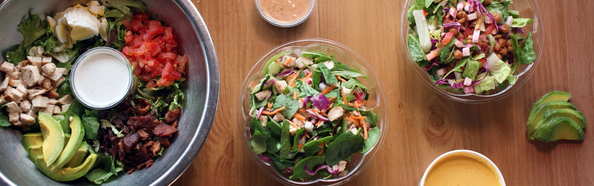Fresh garden salads with grilled chicken and avocado