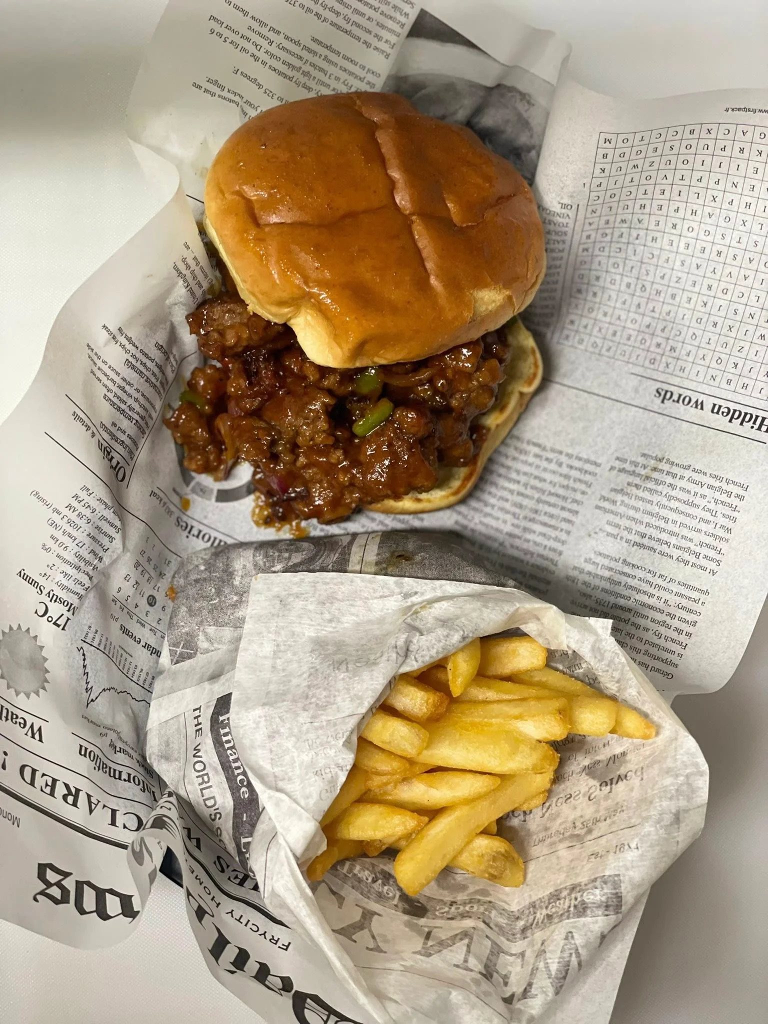 Crispy chicken sandwich with fries in a casual dining setting
