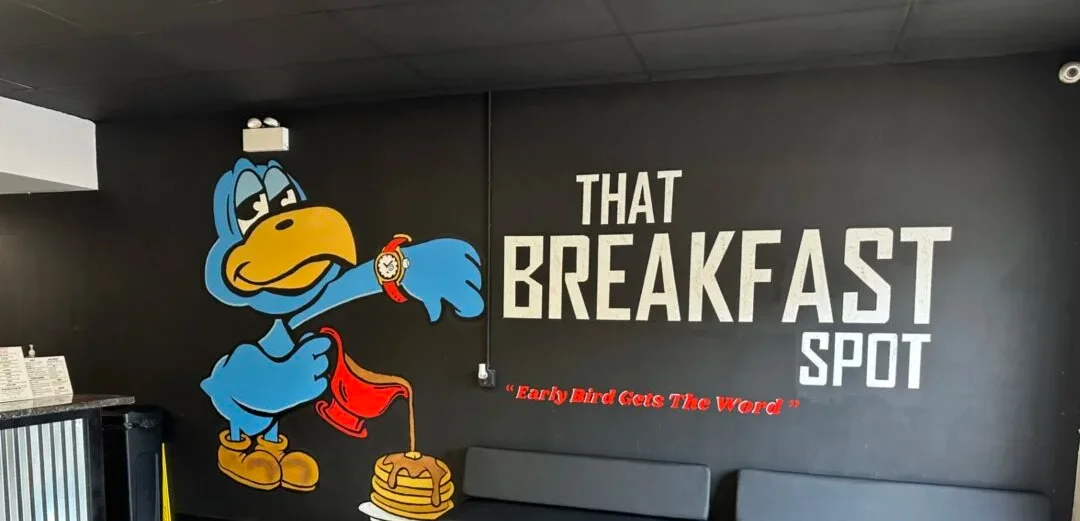 Colorful restaurant interior with a cartoon character and seating area
